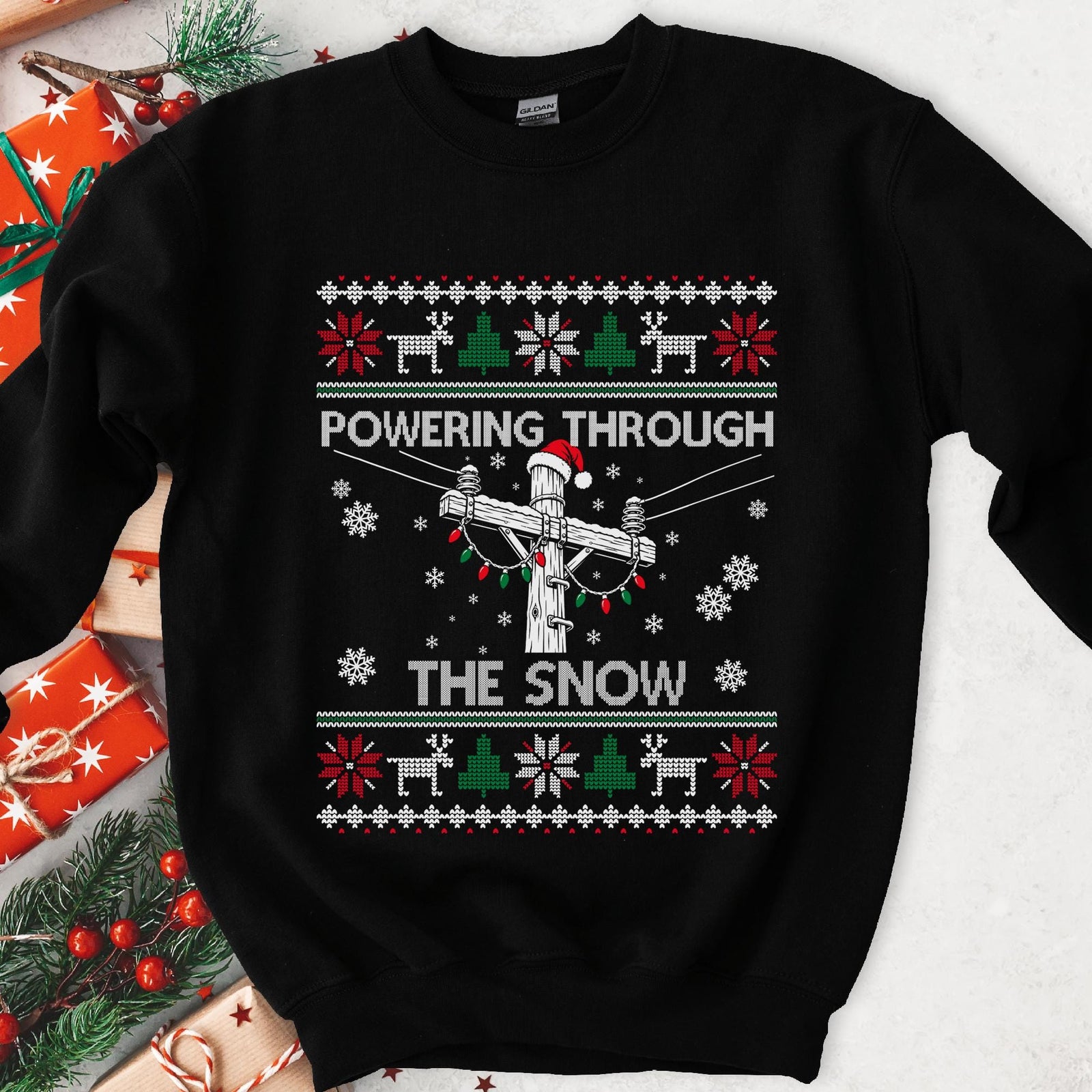 Powering Through the Snow Lineman Christmas Sweatshirt - black crewneck, utility pole in a Santa hat wrapped in lights