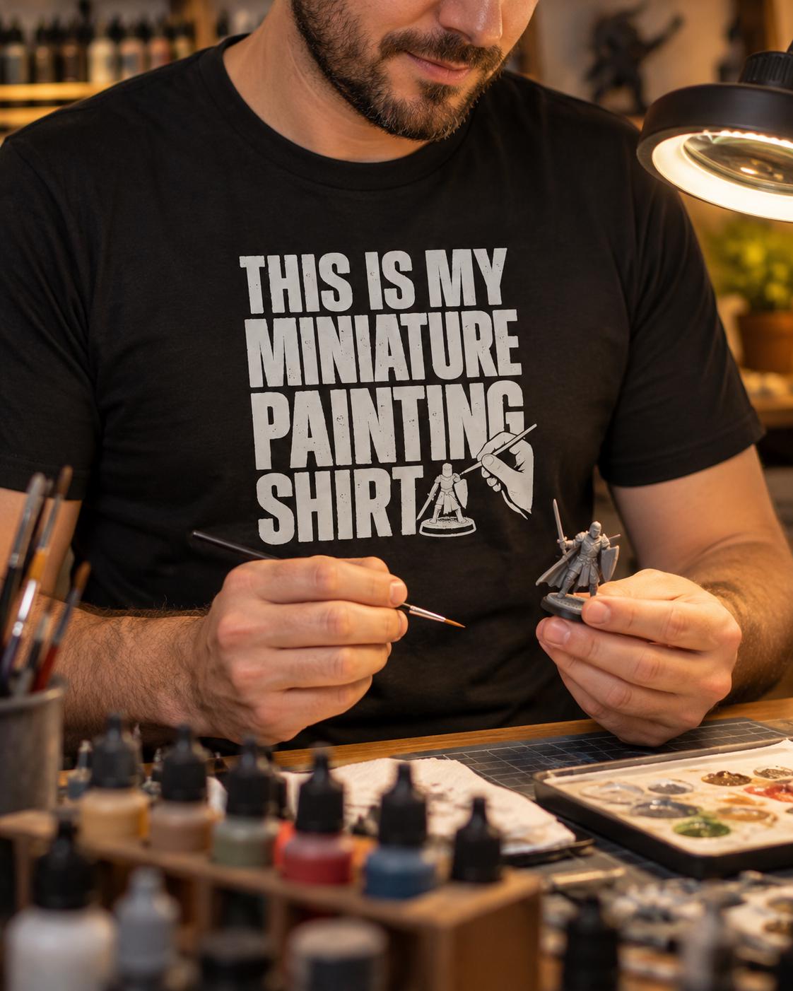 This Is My Miniature Painting Shirt - man in the black t-shirt painting a miniature at his hobby desk