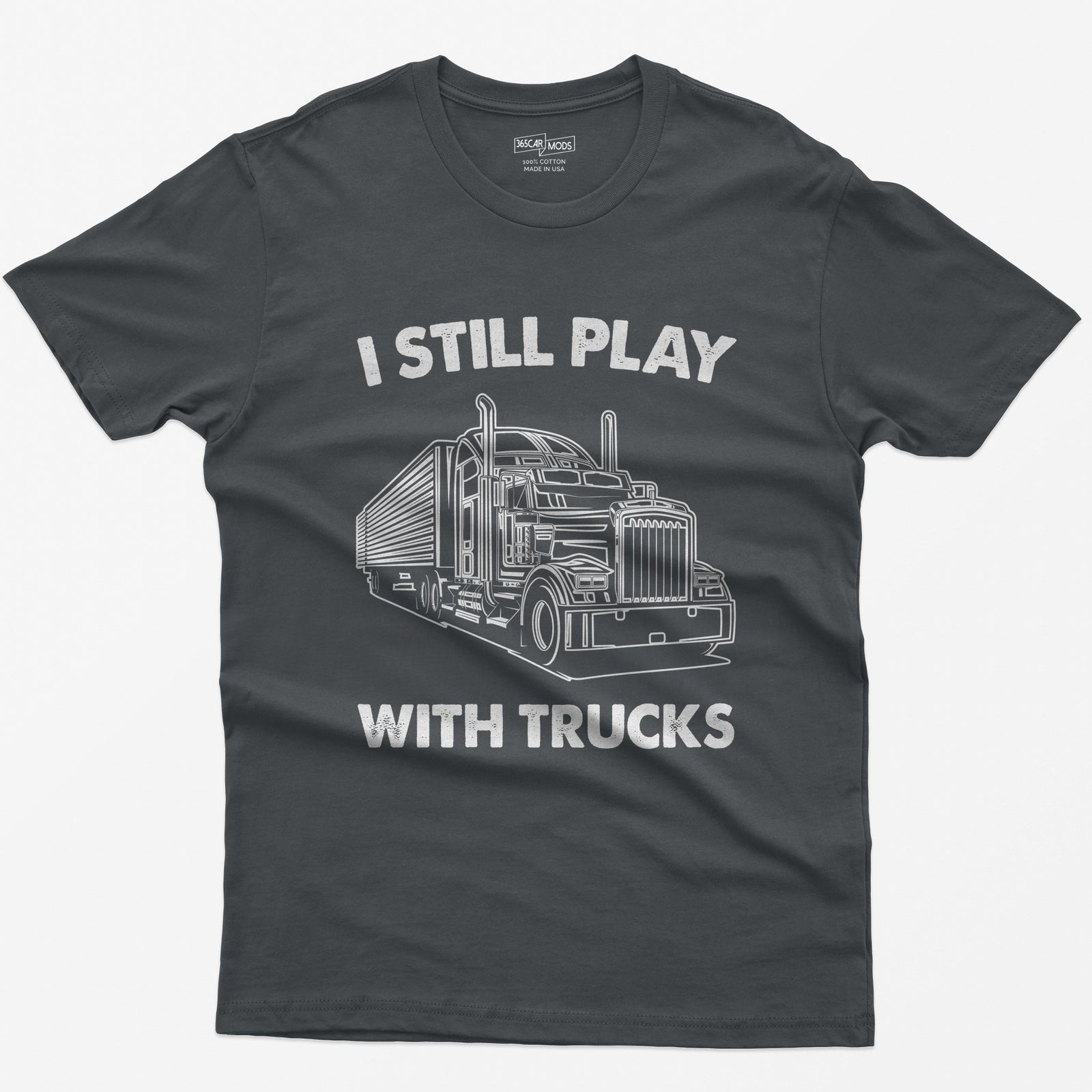 Charcoal t-shirt with I Still Play With Trucks text and a white line drawing of a long-nose semi truck with trailer