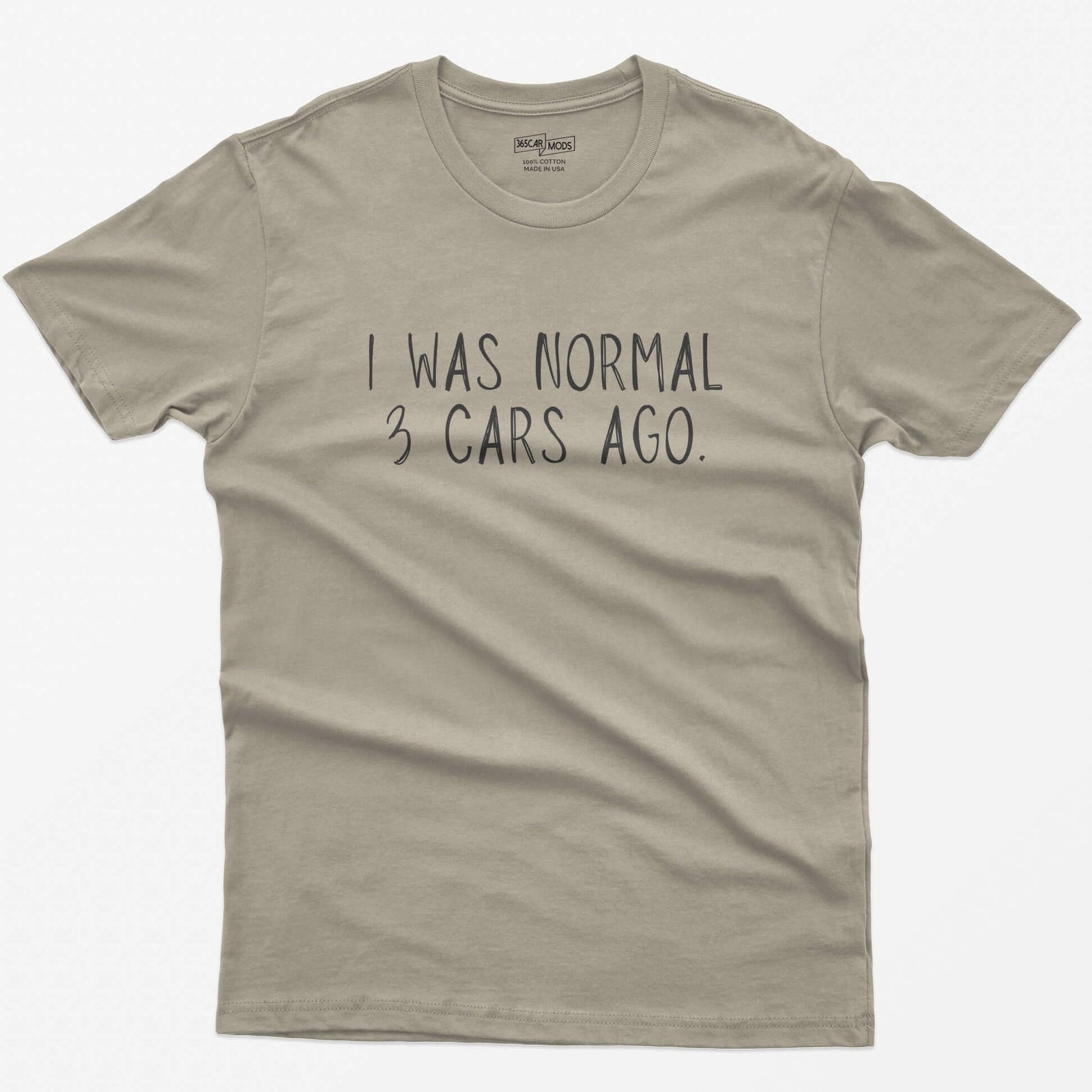 Sand t-shirt with thin hand-lettered white text reading I Was Normal 3 Cars Ago