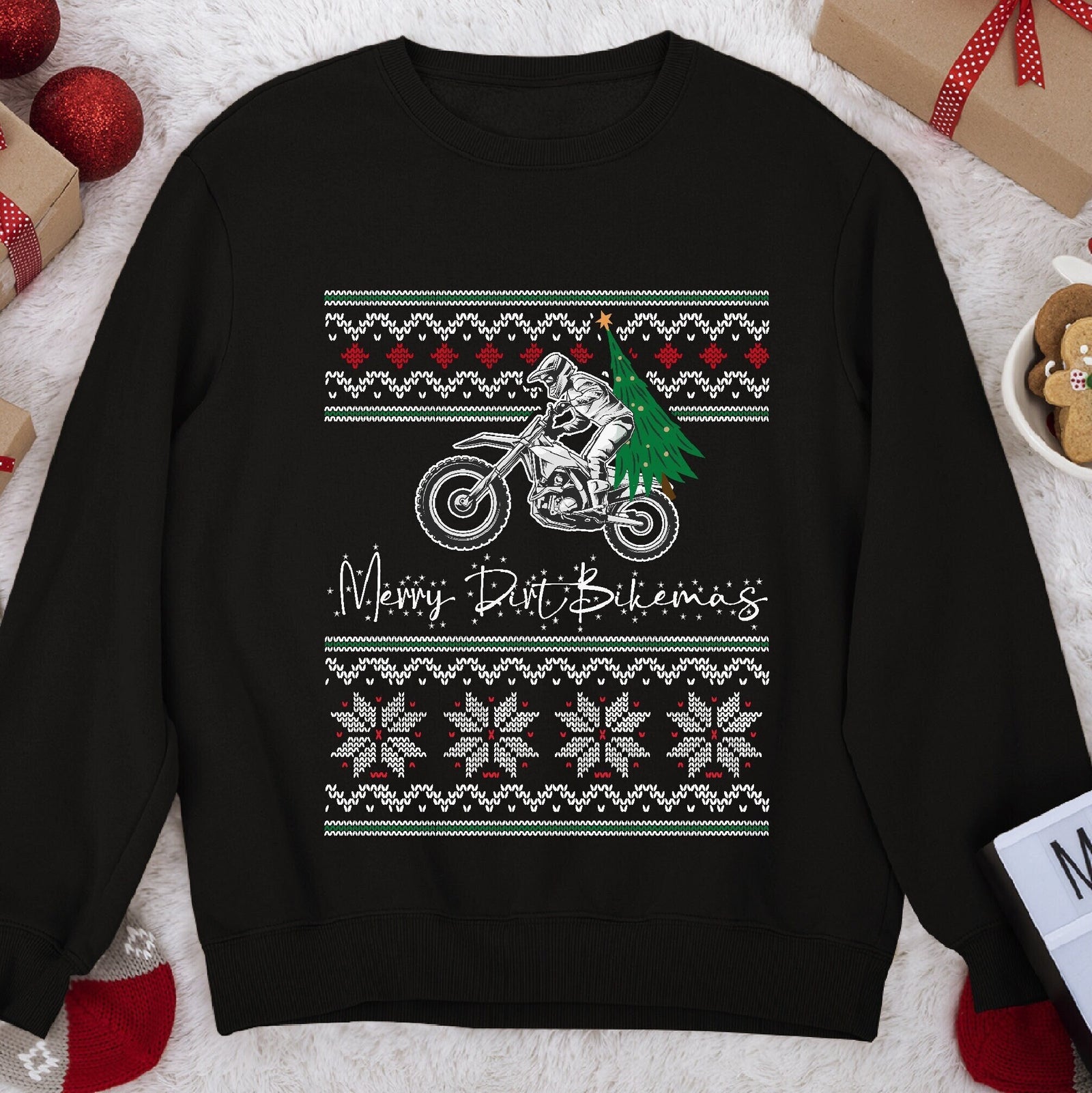 Dark Christmas sweatshirt with a dirt bike rider carrying a tree, script Merry Dirt Bikemas, snowflake knit bands