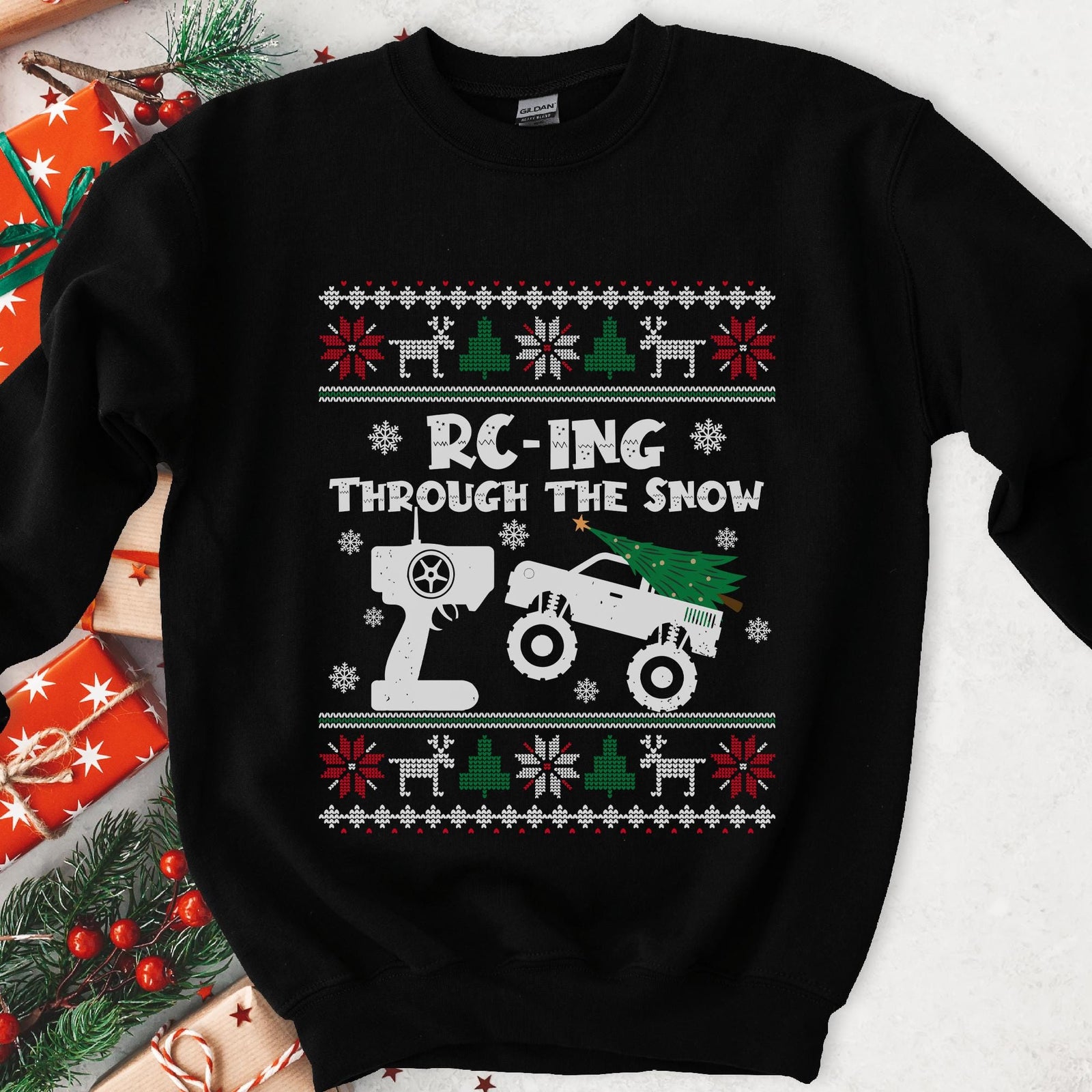Dark Christmas sweatshirt with an RC monster truck and transmitter, RC-ING THROUGH THE SNOW, knit sweater borders