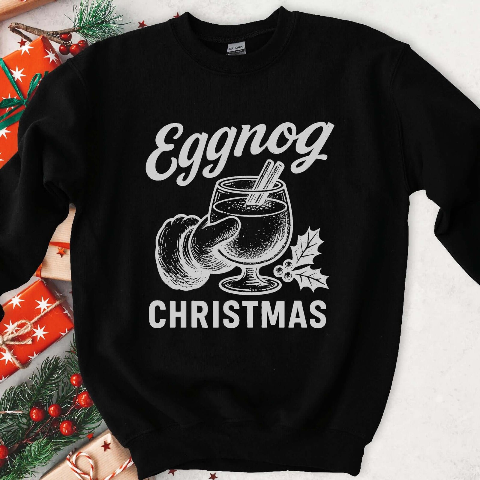 Dark sweatshirt with vintage gray art of Santa's hand holding eggnog with cinnamon sticks, text Eggnog Christmas