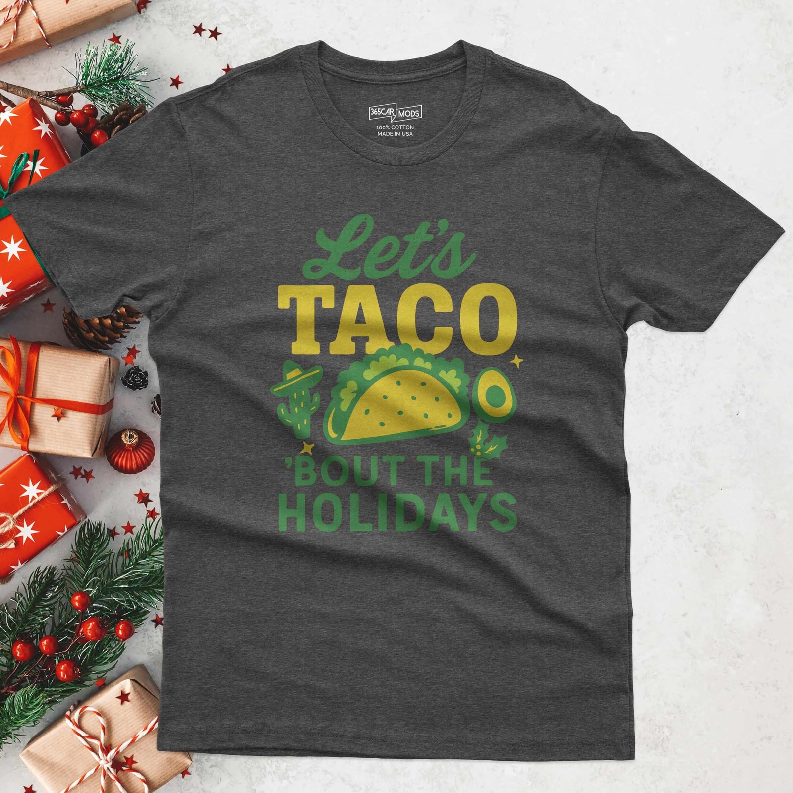 Dark gray t-shirt with the text Let's TACO 'Bout the Holidays in green and yellow, with a taco, avocado and cactus.