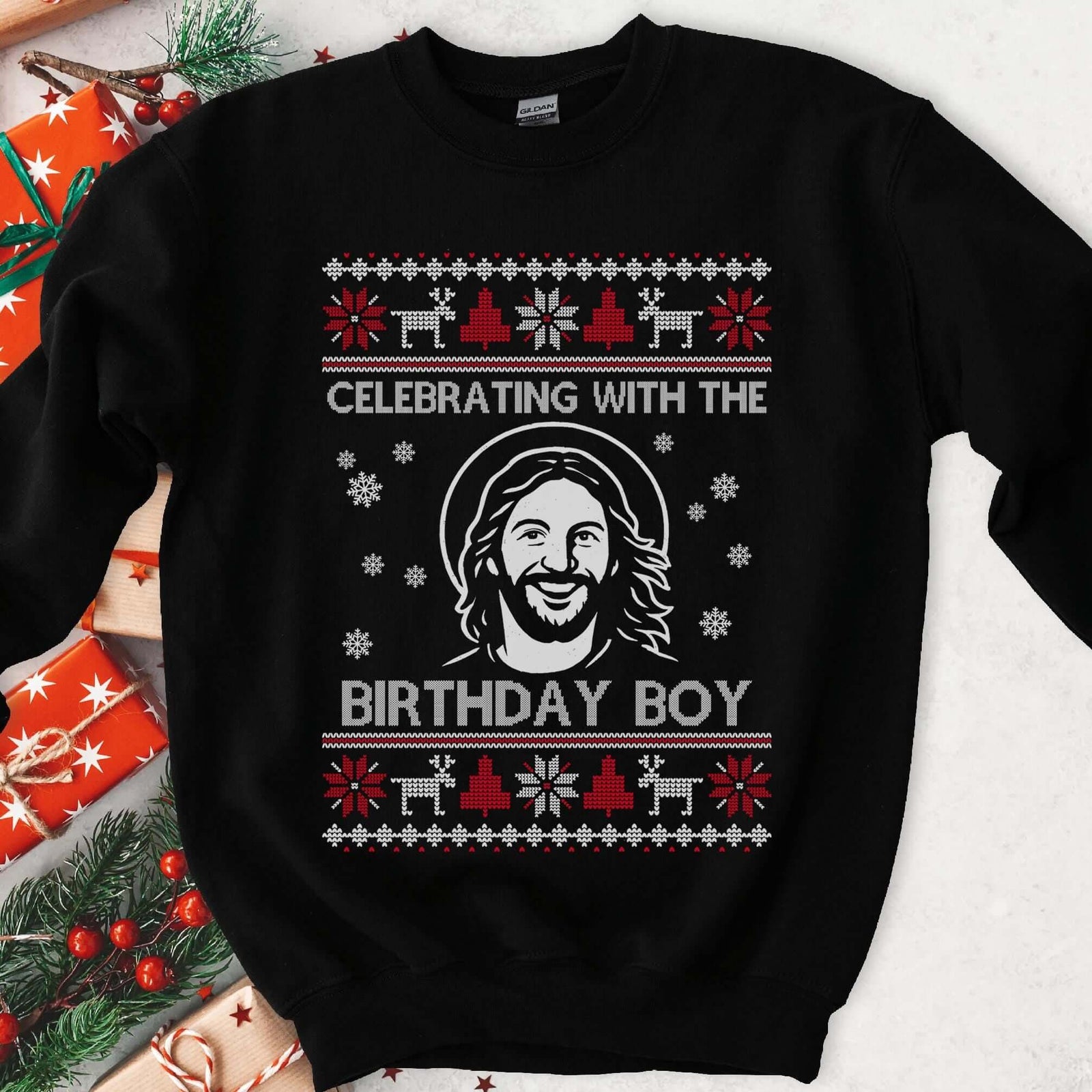 Dark sweatshirt with red and white knit borders and smiling Jesus with halo, text Celebrating With The Birthday Boy