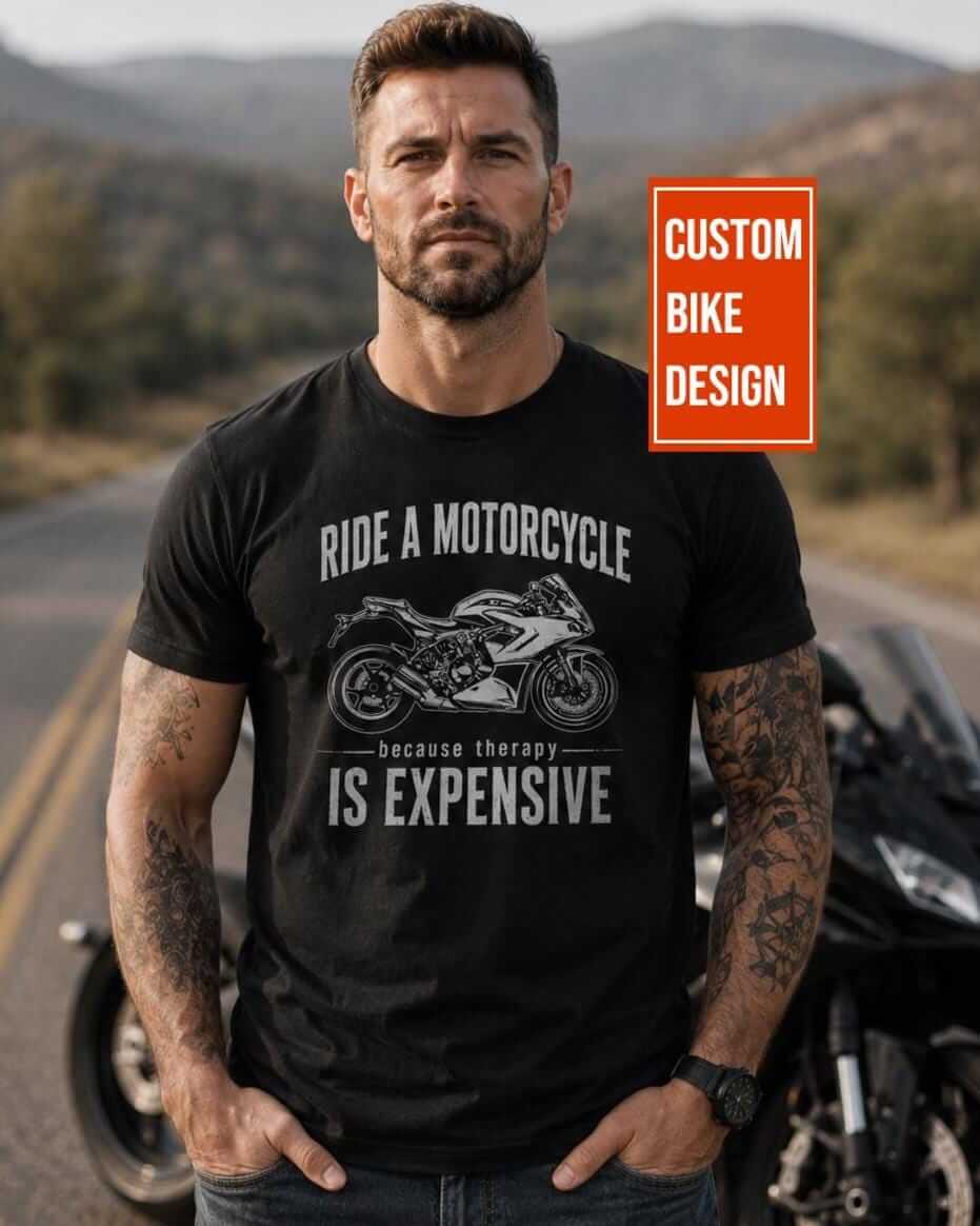 A black short-sleeved t-shirt featuring a white graphic of a sport motorcycle. The text reads RIDE A MOTORCYCLE because therapy IS EXPENSIVE.