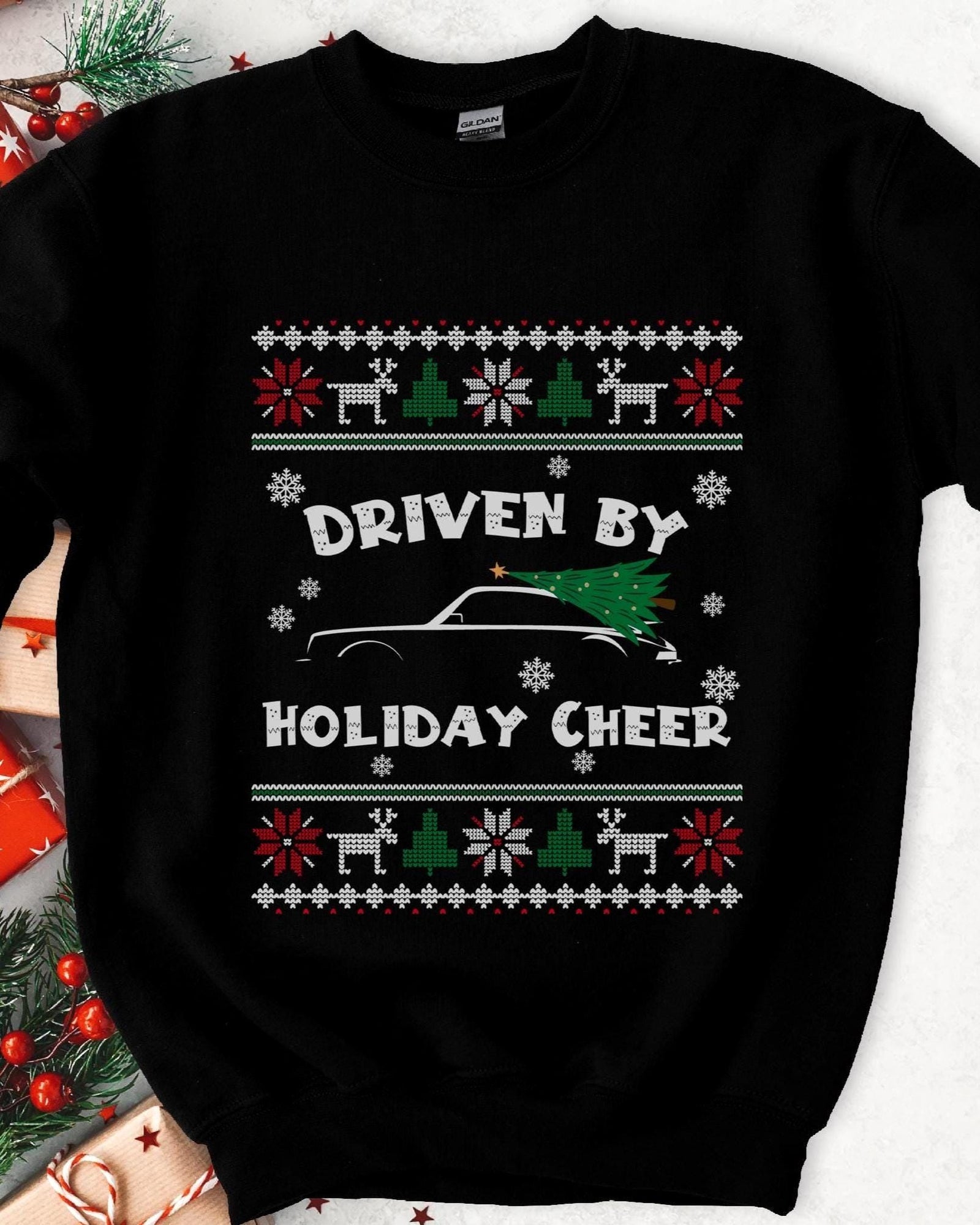 Dark Christmas sweatshirt with a sports car carrying a tree on the roof, DRIVEN BY HOLIDAY CHEER, knit borders