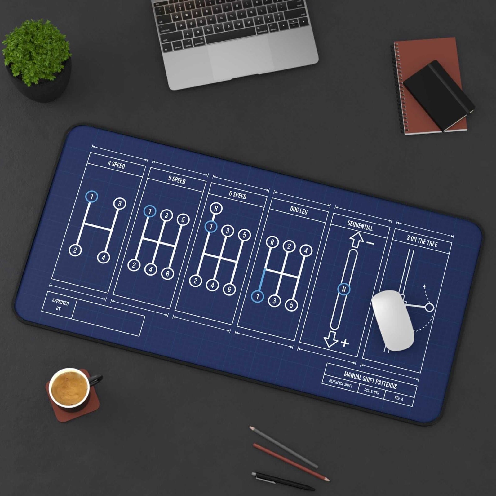 Extended manual shift patterns desk mat, top view on a dark desk