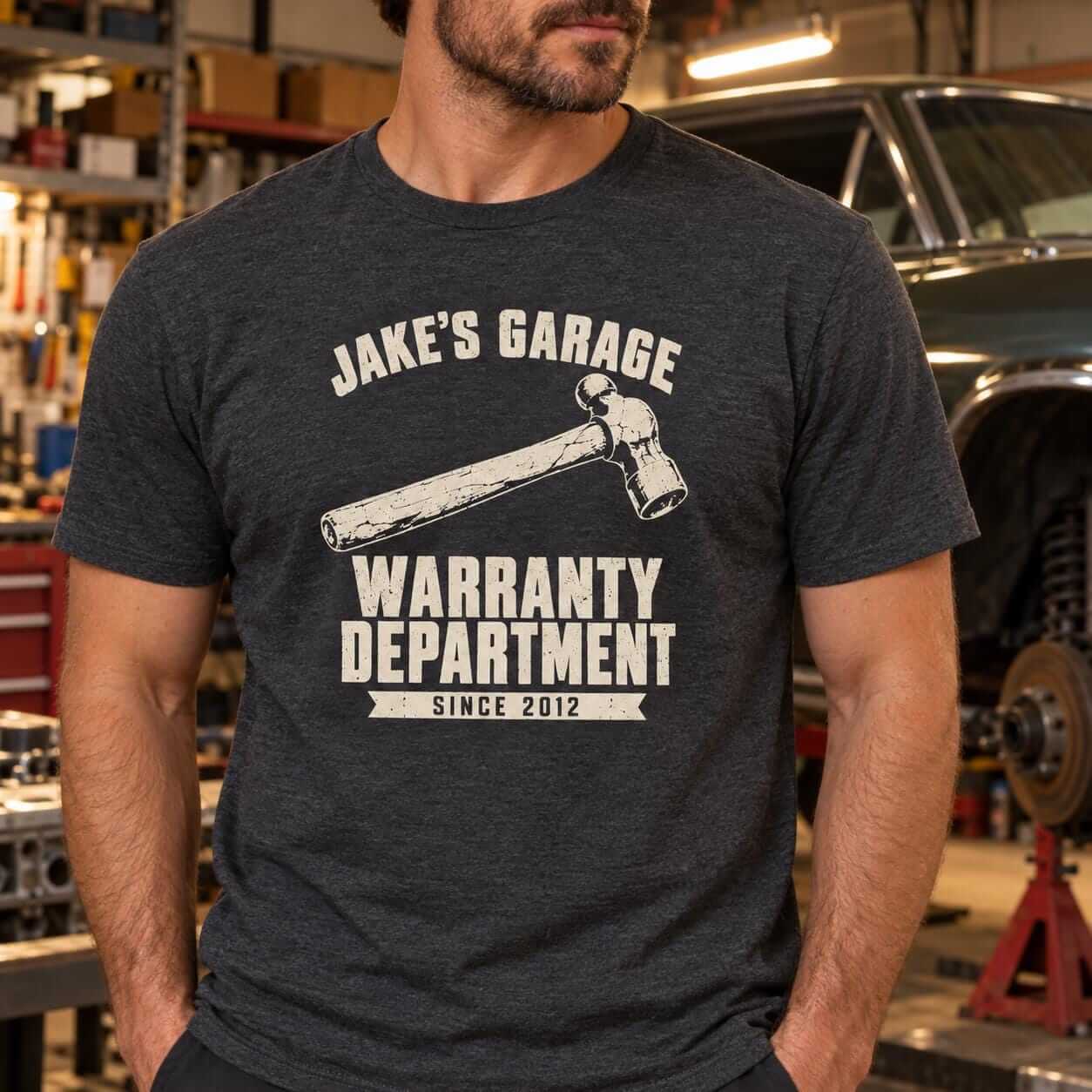 Man wearing the Dark Heather Warranty Department t-shirt personalized with a different name and year