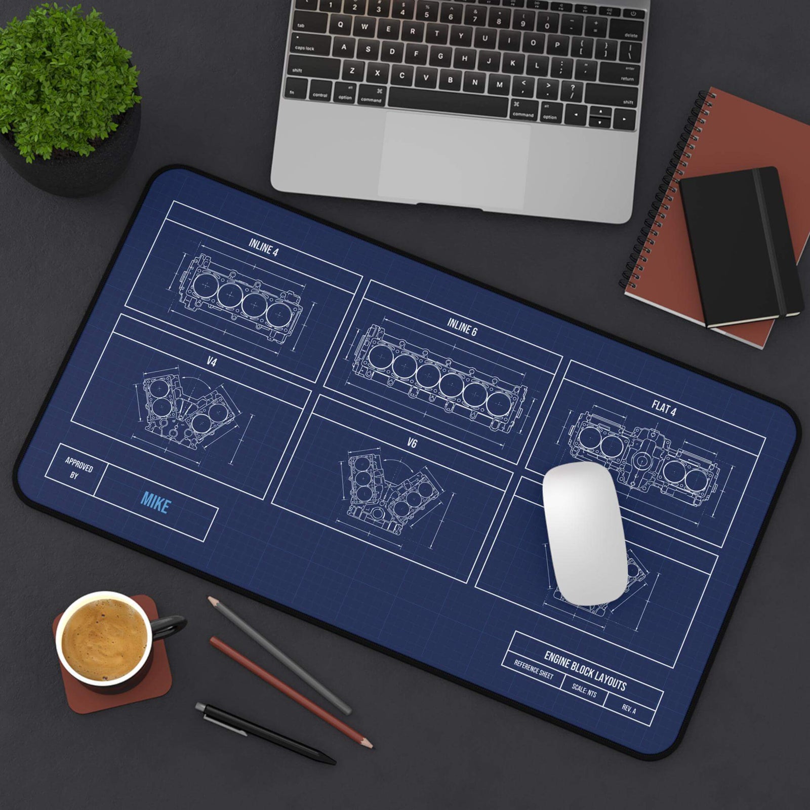 Engine block blueprint desk mat, angled top view on a dark desk