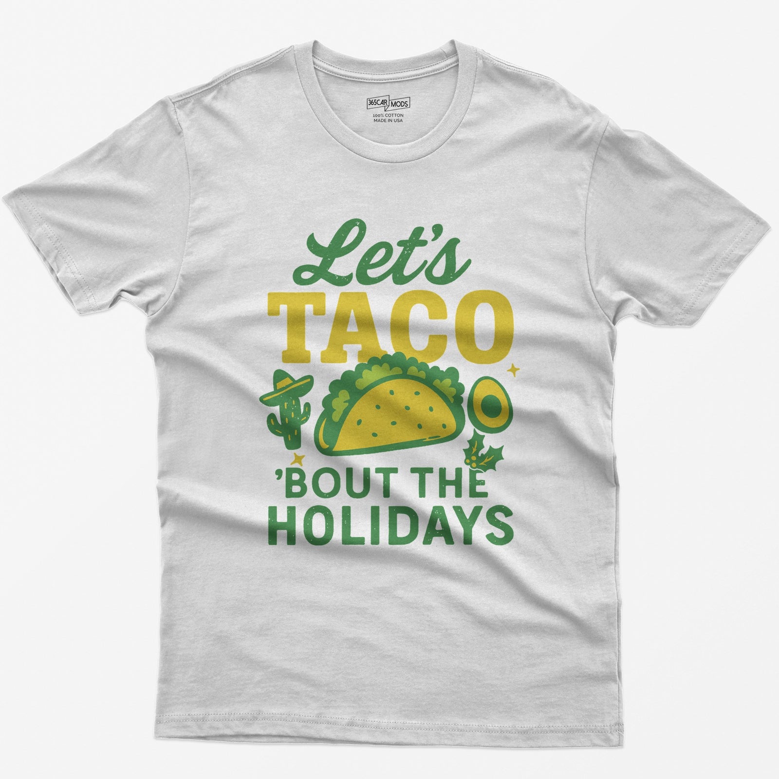 White t-shirt with Let's Taco Bout The Holidays in green and yellow, with a taco, a cactus in a sombrero, avocado and holly