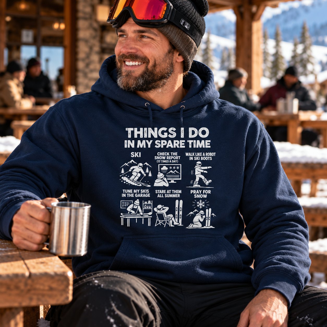 Man in the navy ski hoodie with a mug of coffee at the ski lodge