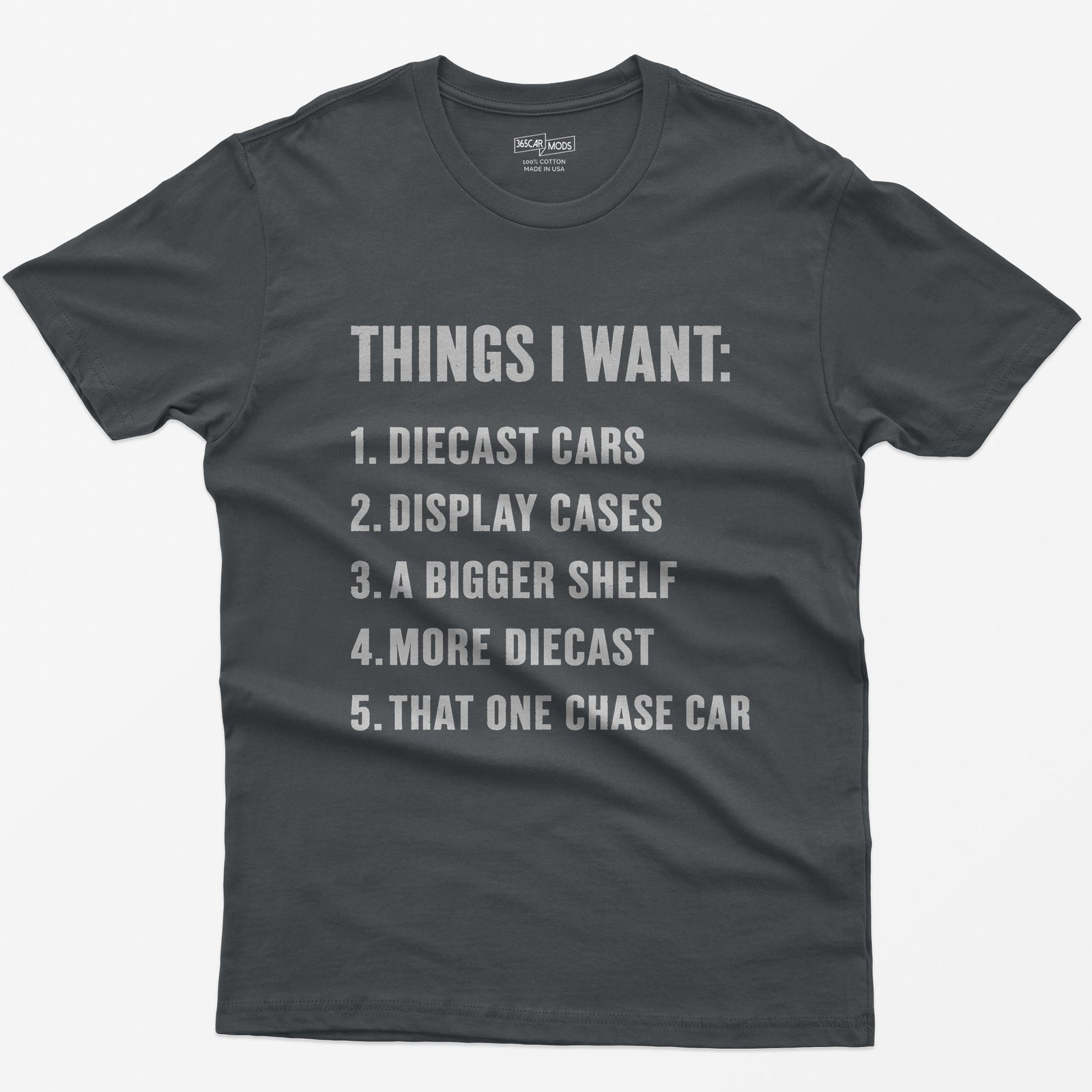 Charcoal t-shirt with white block text Things I Want list: diecast cars, display cases, a bigger shelf, that one chase car