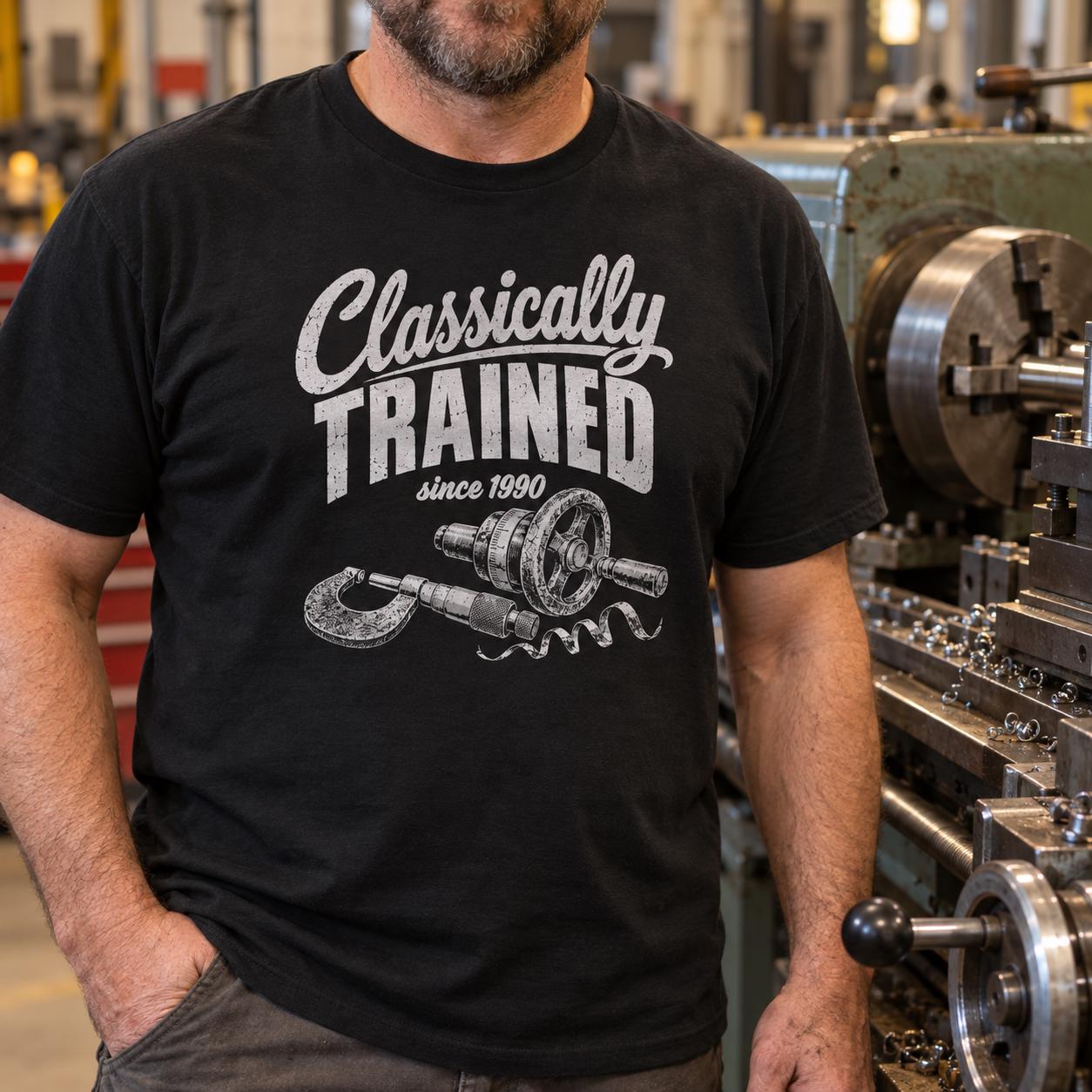 Man in a black Classically Trained machinist t-shirt standing in a machine shop next to a manual lathe