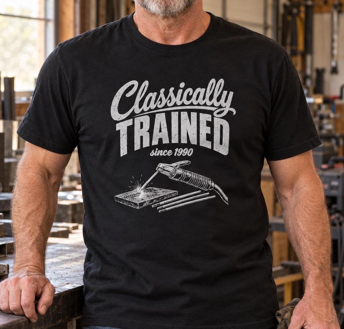 Welder in a black Classically Trained t-shirt in a fabrication shop
