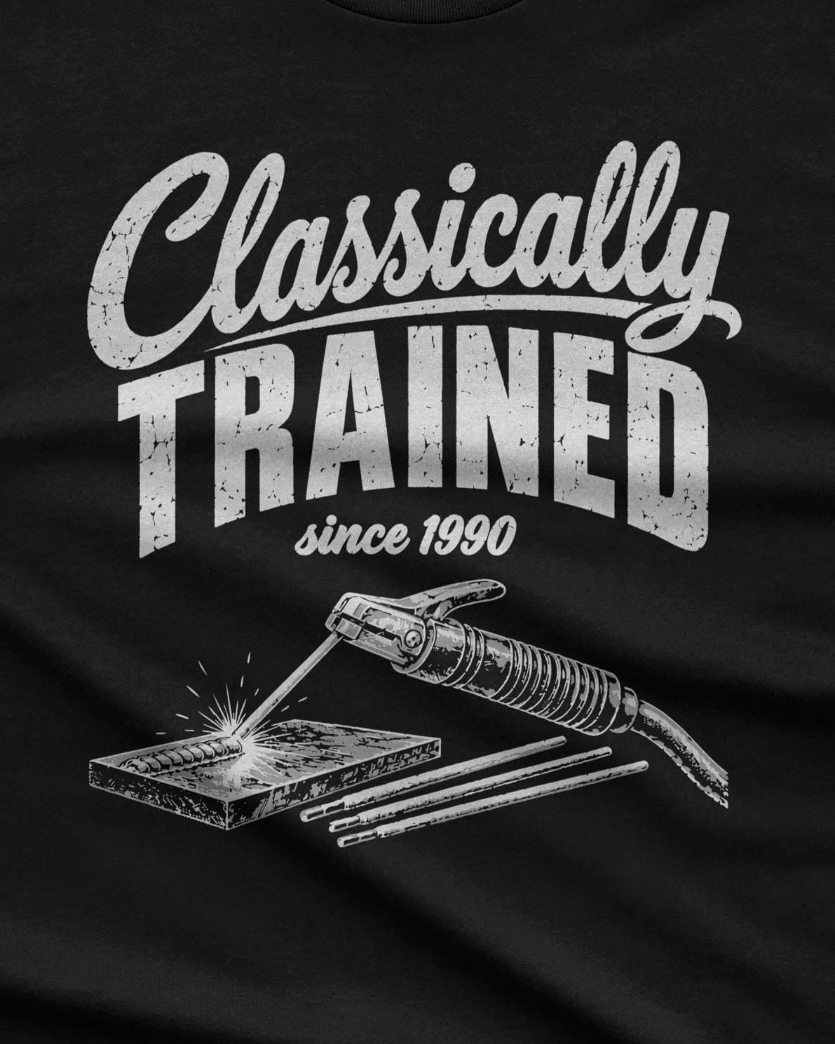Close-up of the Classically Trained welder print: a stick welding stinger, a plate with a fresh bead and three rods, with the year underneath