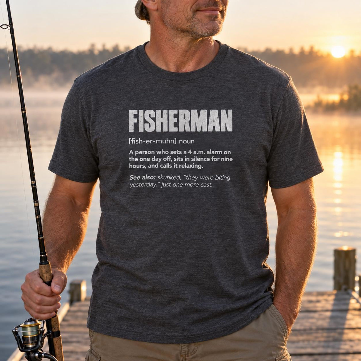 Fisherman Definition T-Shirt - man in the dark heather t-shirt holding a rod on a dock at sunrise
