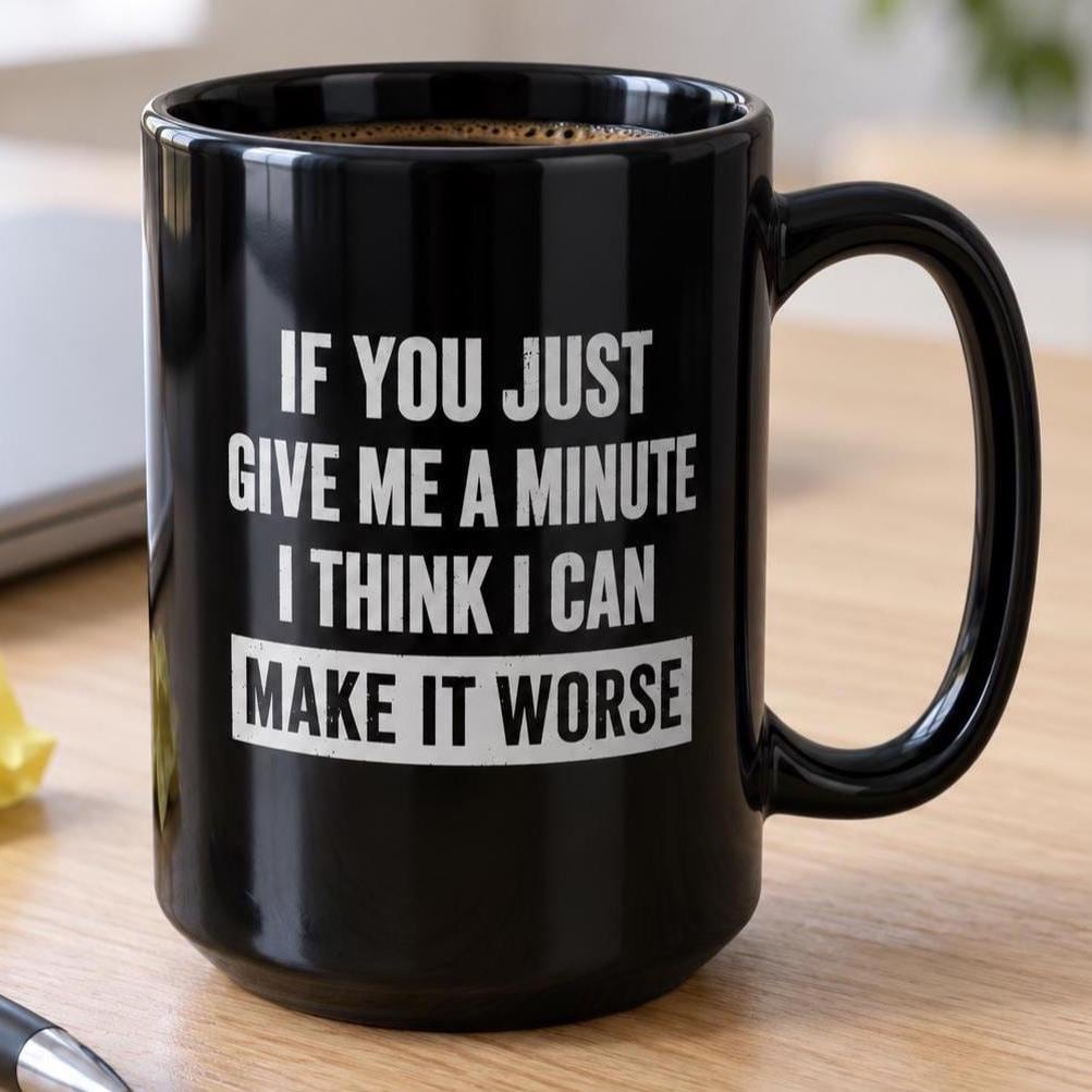 The 15 oz Give Me A Minute I Can Make It Worse mug on an office desk