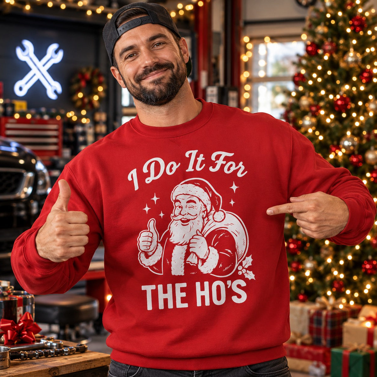 Man wearing the red I Do It for the Ho's sweatshirt next to a Christmas tree