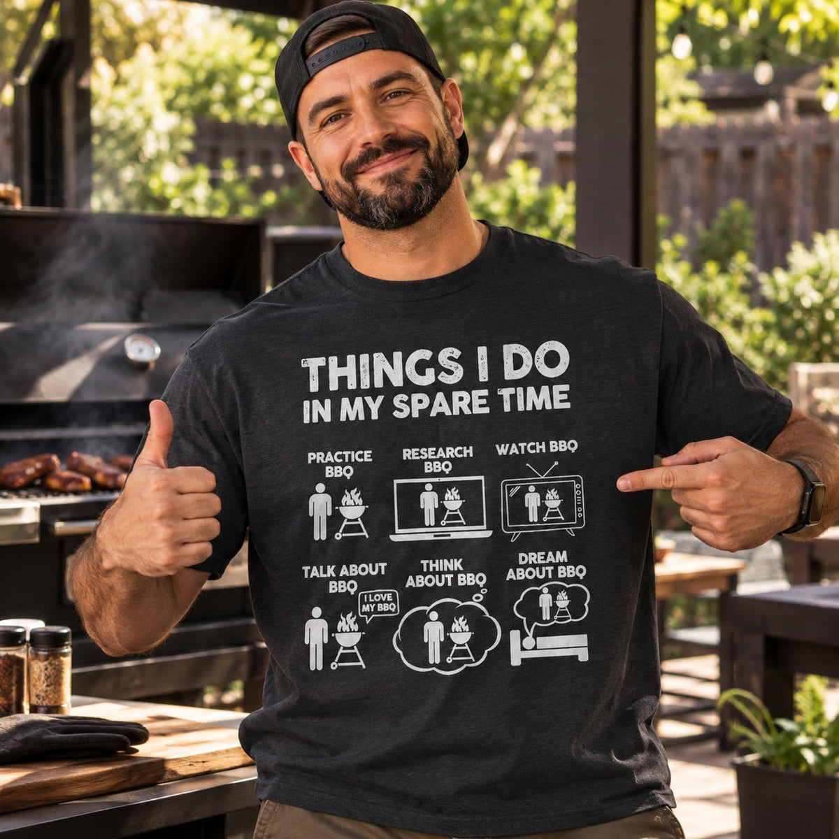 Man wearing the Things I Do in My Spare Time BBQ t-shirt next to a smoker
