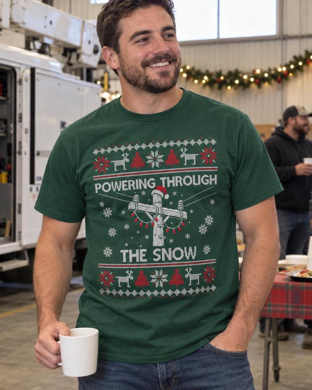 Powering Through the Snow Lineman Christmas T-Shirt - lineman in the forest green tee at a crew holiday party