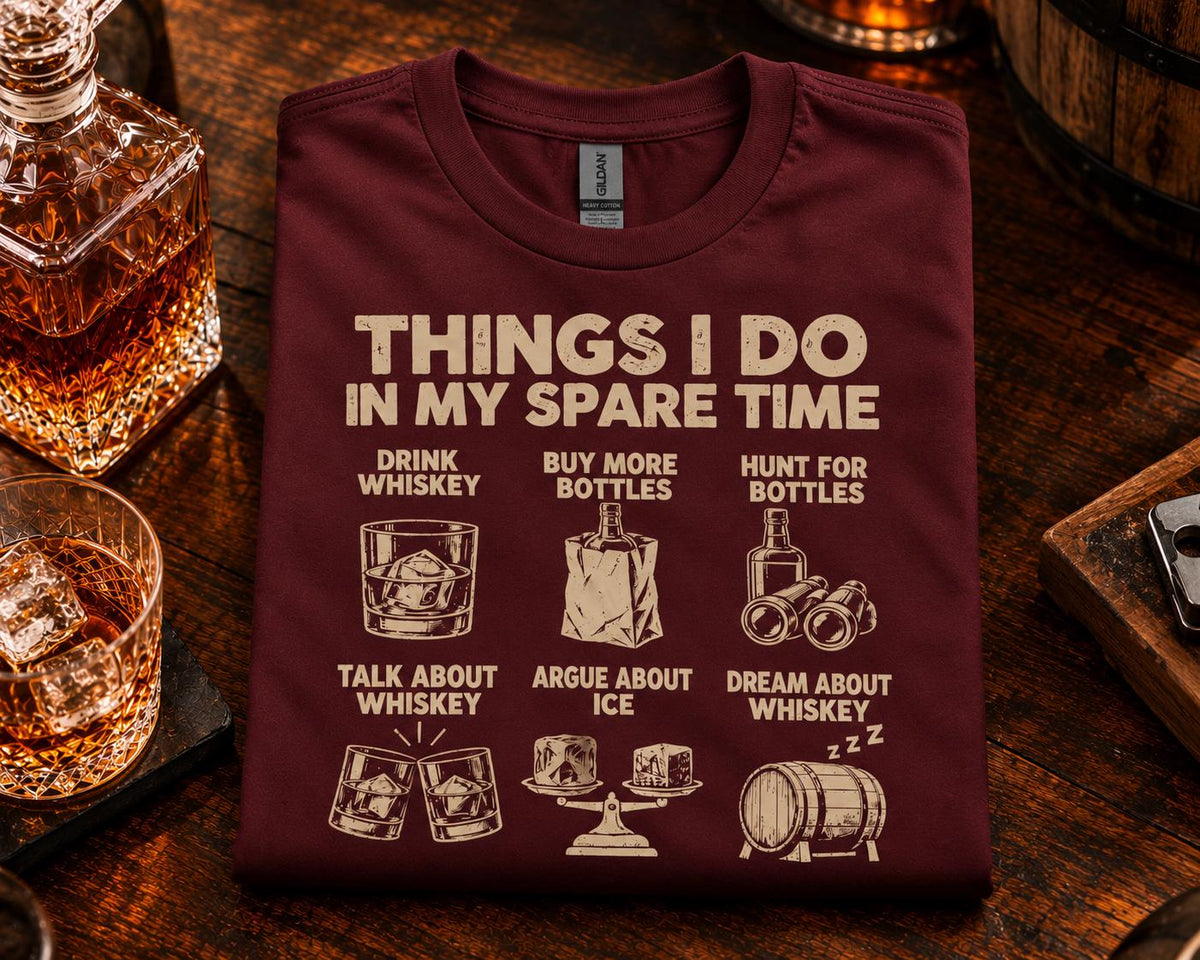 Things I Do In My Spare Time Whiskey T-Shirt - maroon t-shirt folded on a bar with a decanter and whiskey glasses