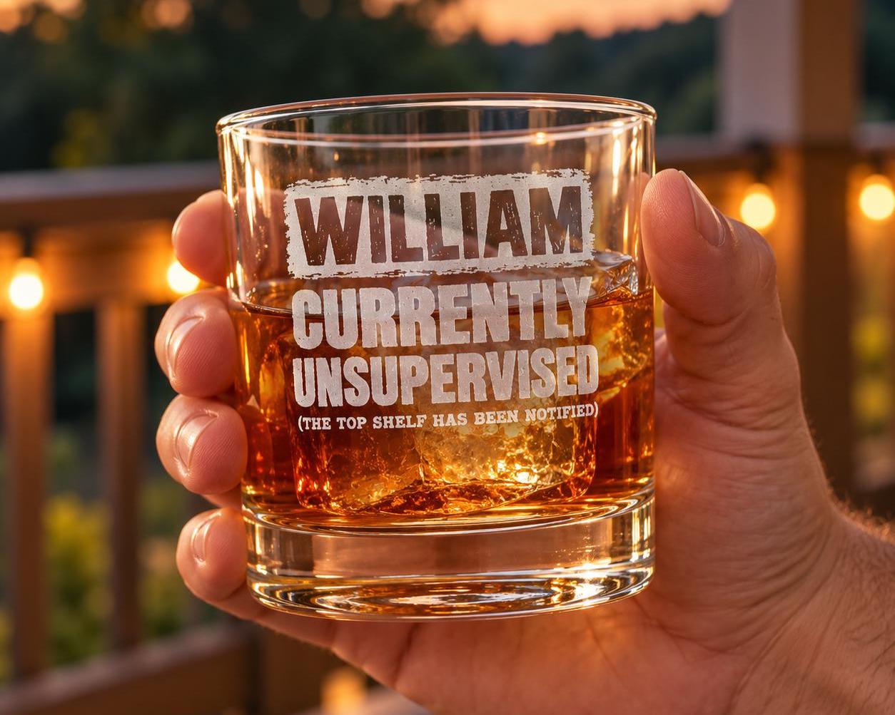 Currently Unsupervised Personalized Whiskey Glass - glass held in hand on a porch at dusk
