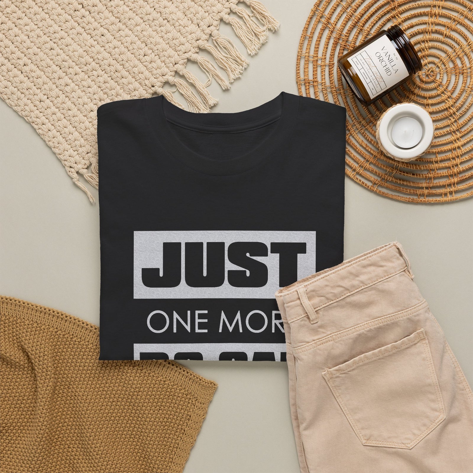 Black Just One More RC Car I Promise t-shirt laid flat with a candle and jeans