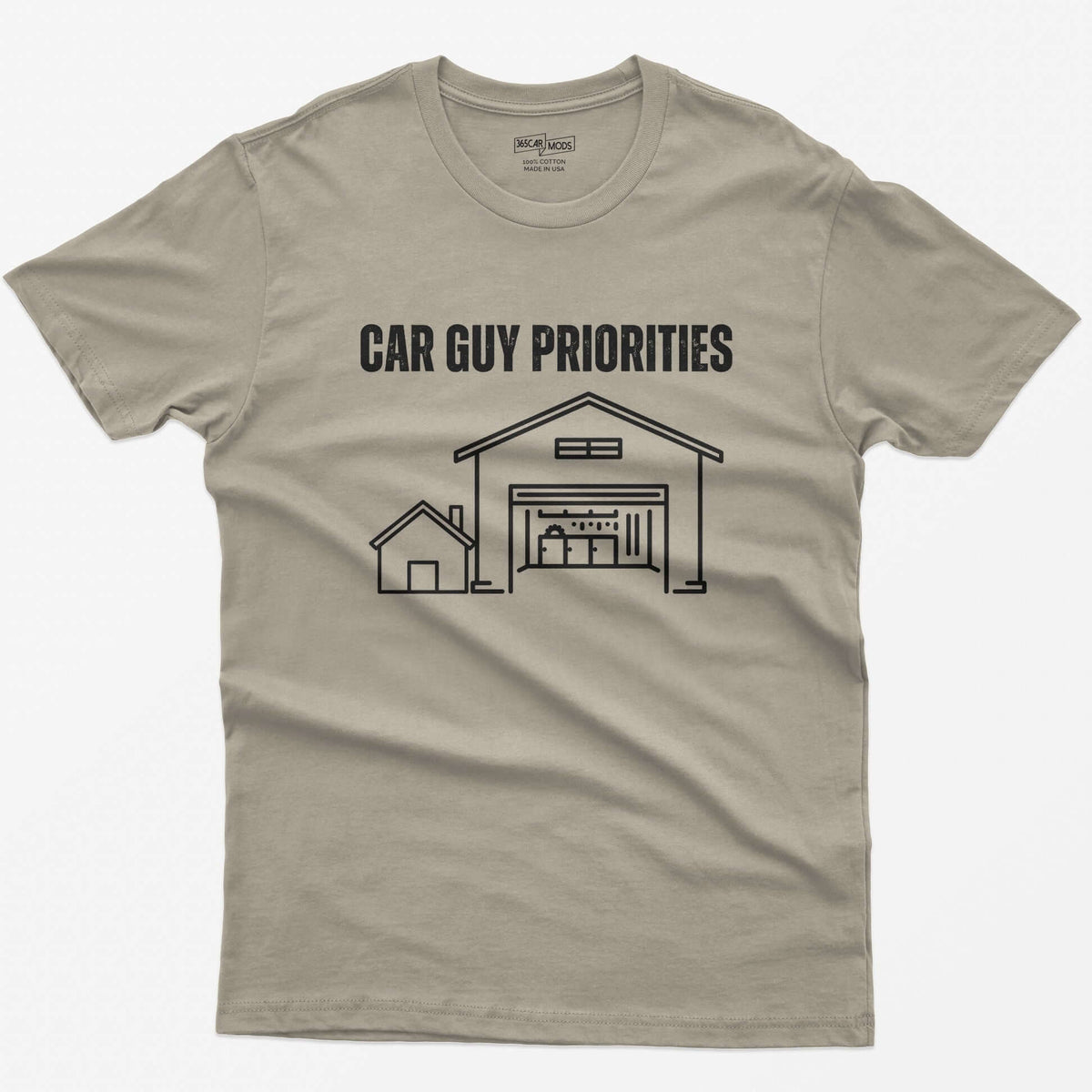Sand t-shirt with Car Guy Priorities and a line drawing of a tiny house beside a huge garage with a car on a lift