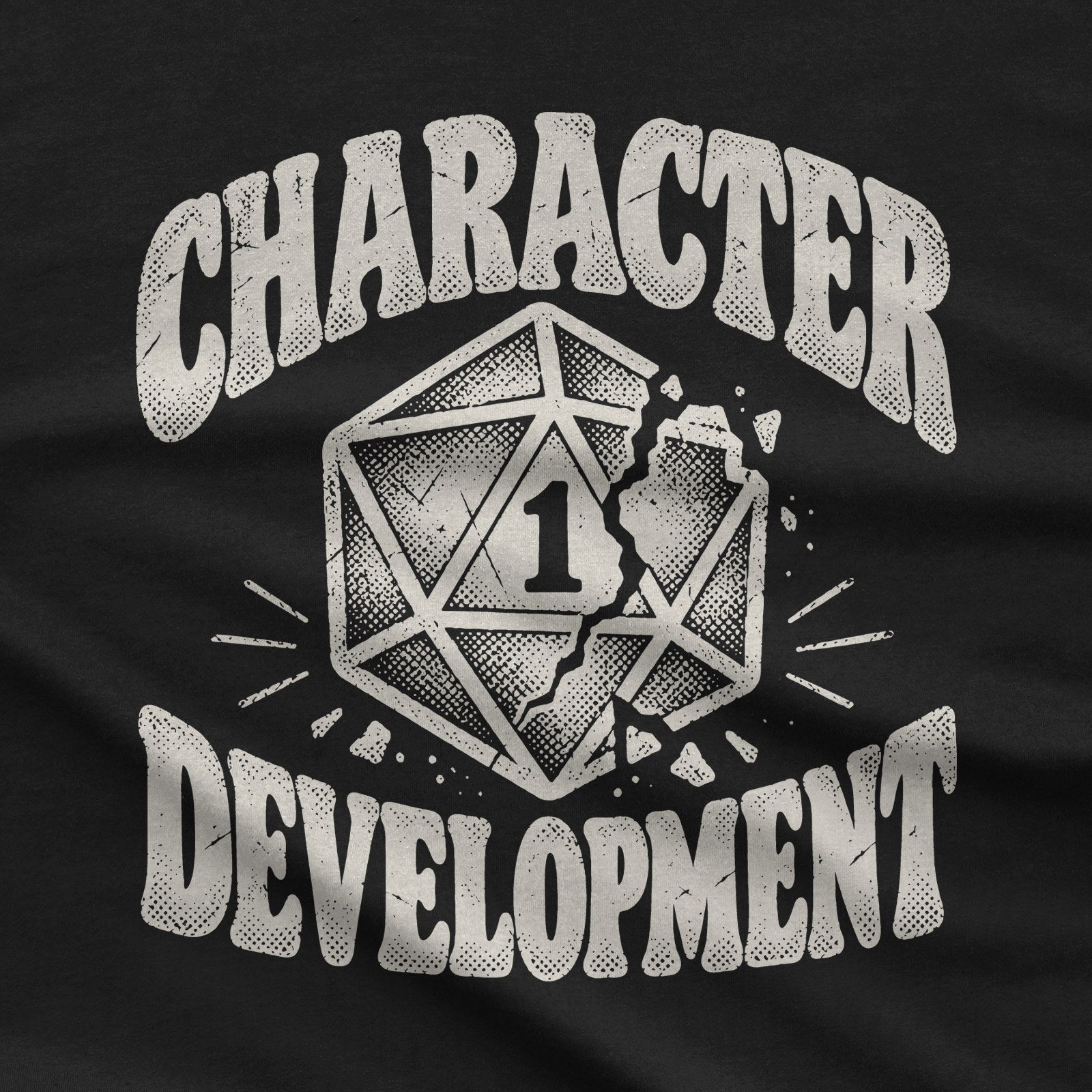 Character Development T-Shirt | Nat 1 D20 Tabletop RPG Tee design close-up: cracked twenty-sided die showing a 1 with distressed cream lettering.