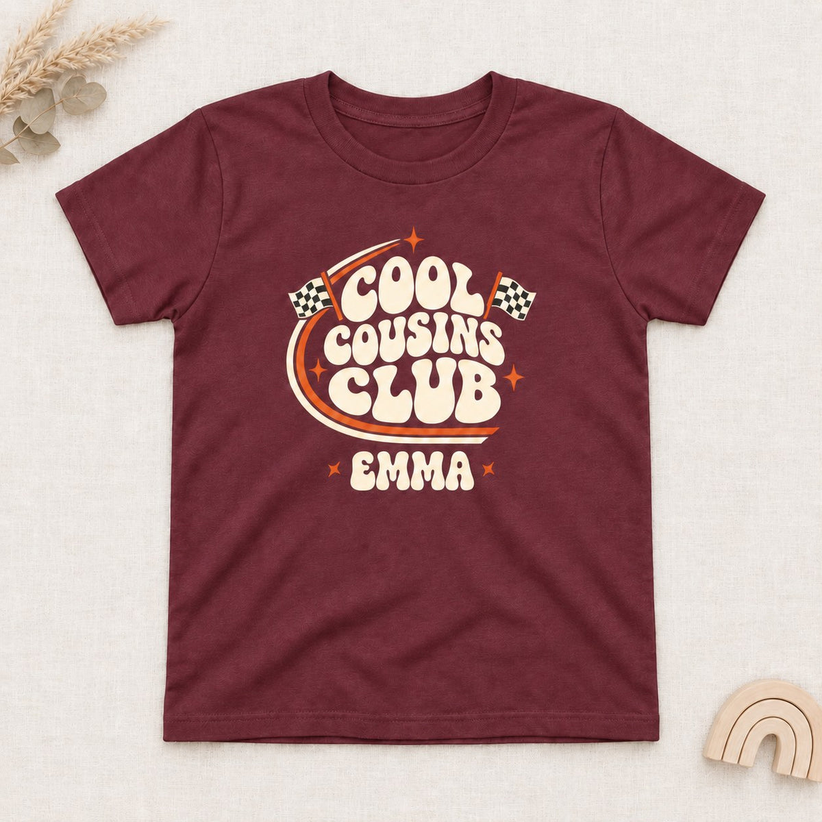 Maroon t-shirt with a personalized Cool Cousins Club print with racing flags and a first name