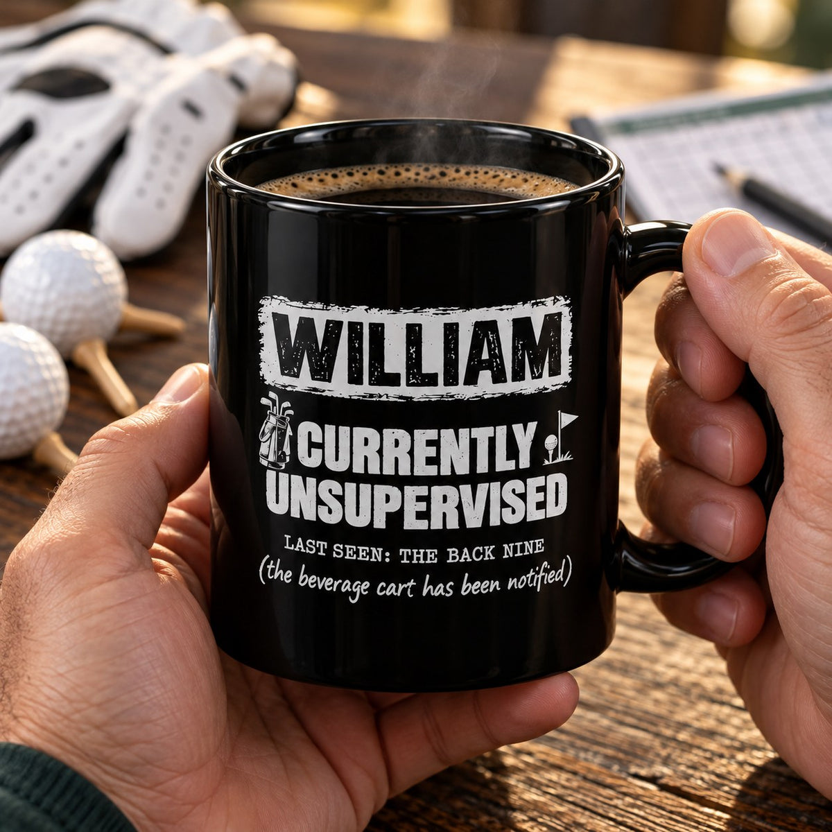 Hands holding the personalized Currently Unsupervised golf mug full of coffee