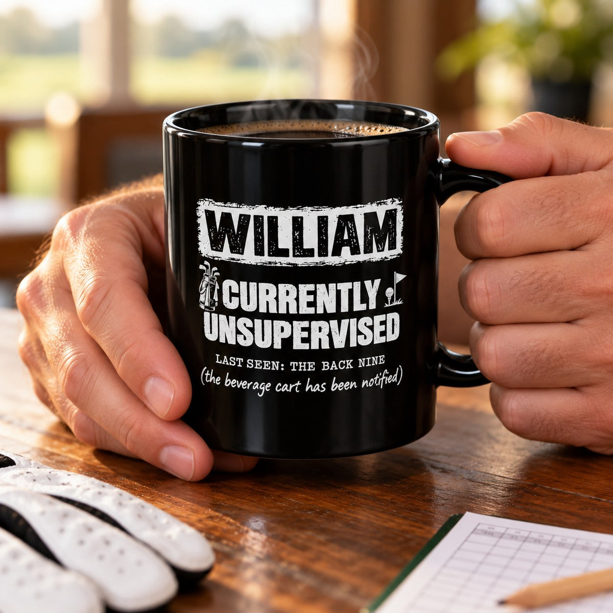 Hand holding the personalized Currently Unsupervised golf coffee mug next to golf balls