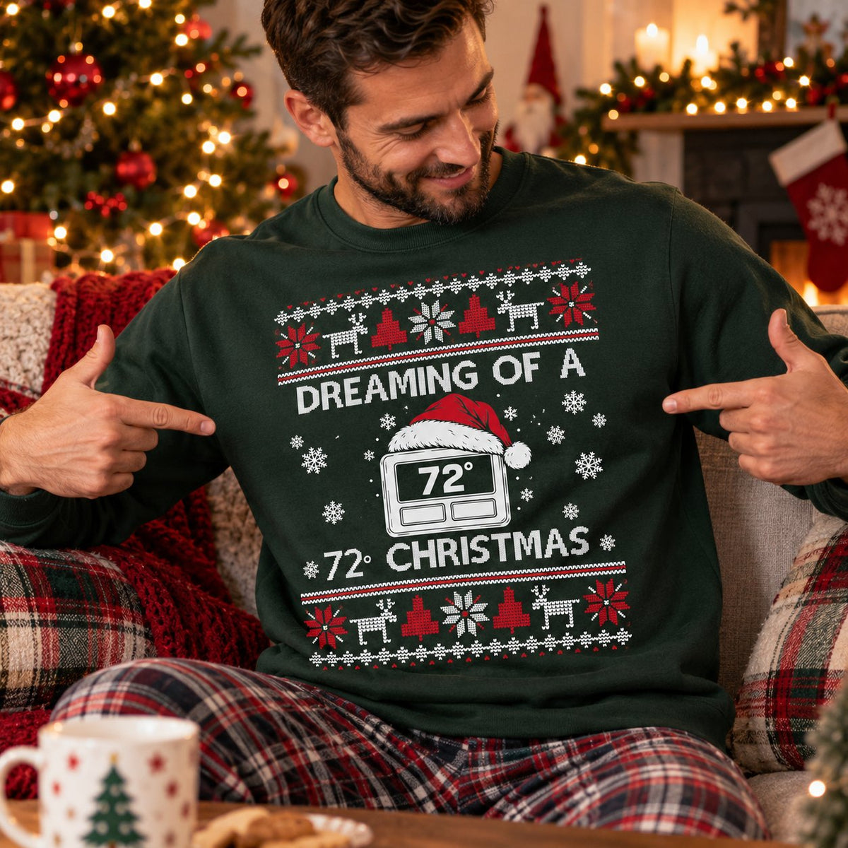 HVAC tech in the green Christmas sweatshirt pointing at the thermostat print by the Christmas tree