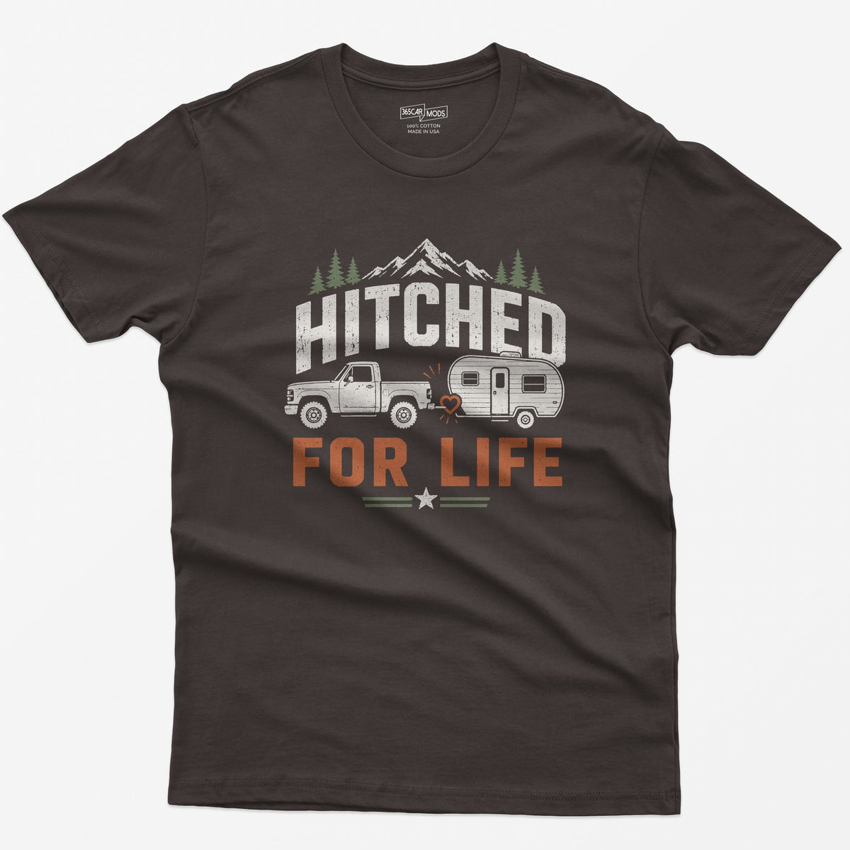 Dark Chocolate t-shirt with Hitched For Life, a pickup towing a travel trailer joined by a heart-shaped hitch, mountains and pines