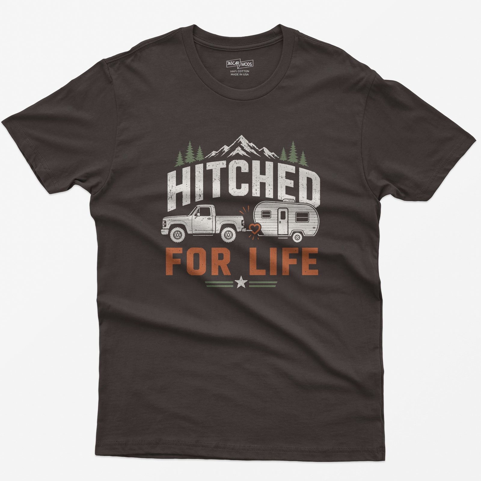 Dark Chocolate t-shirt with Hitched For Life, a pickup towing a travel trailer joined by a heart-shaped hitch, mountains and pines