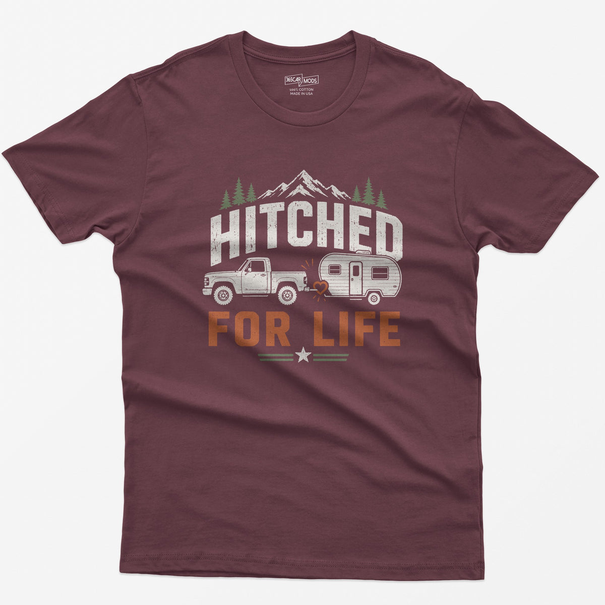 Maroon t-shirt with Hitched For Life, a pickup towing a travel trailer joined by a heart-shaped hitch, mountains and pines