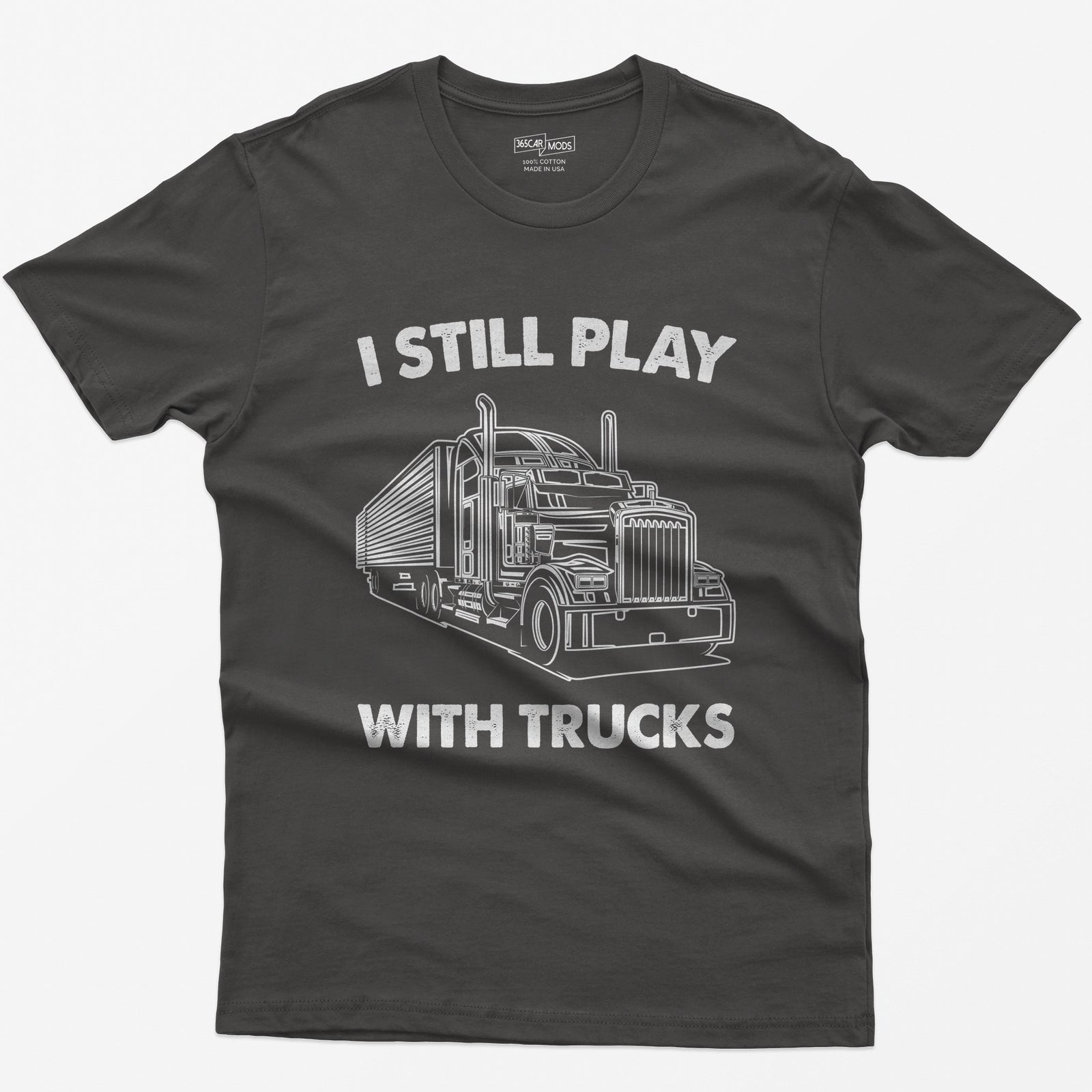 Dark Heather t-shirt with I Still Play With Trucks text and a white line drawing of a long-nose semi truck with trailer