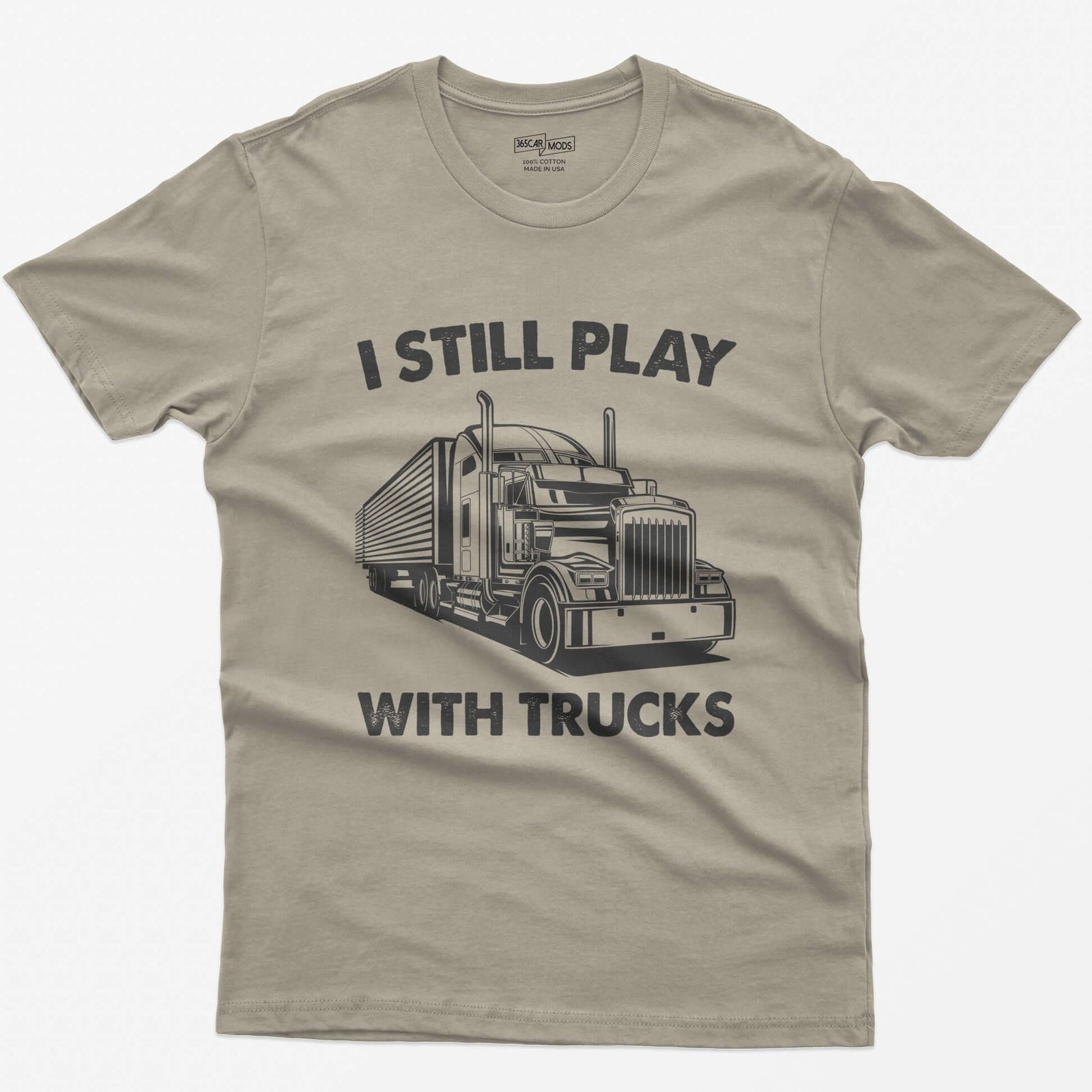 Sand t-shirt with I Still Play With Trucks text and a white line drawing of a long-nose semi truck with trailer