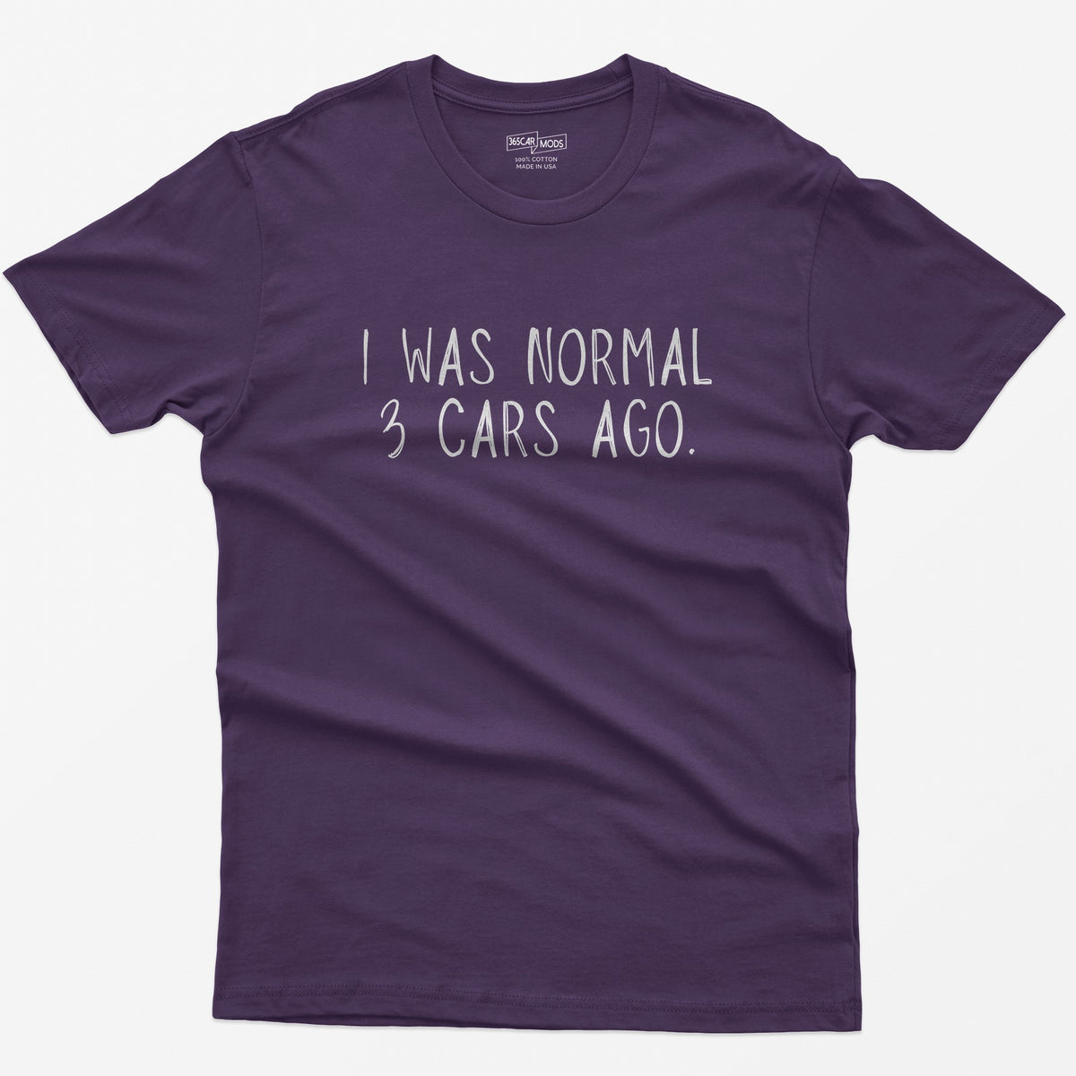 Purple t-shirt with thin hand-lettered white text reading I Was Normal 3 Cars Ago