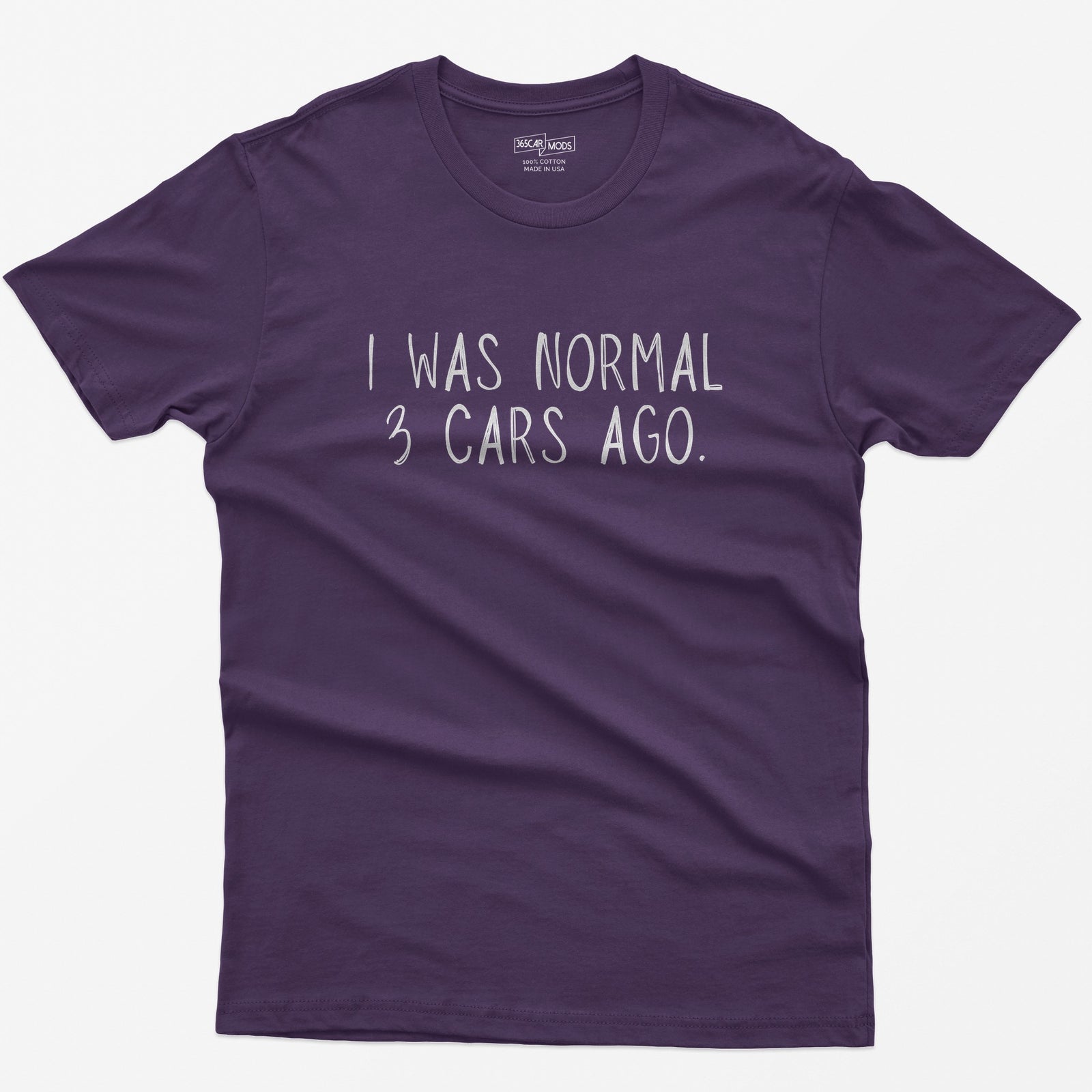 Purple t-shirt with thin hand-lettered white text reading I Was Normal 3 Cars Ago