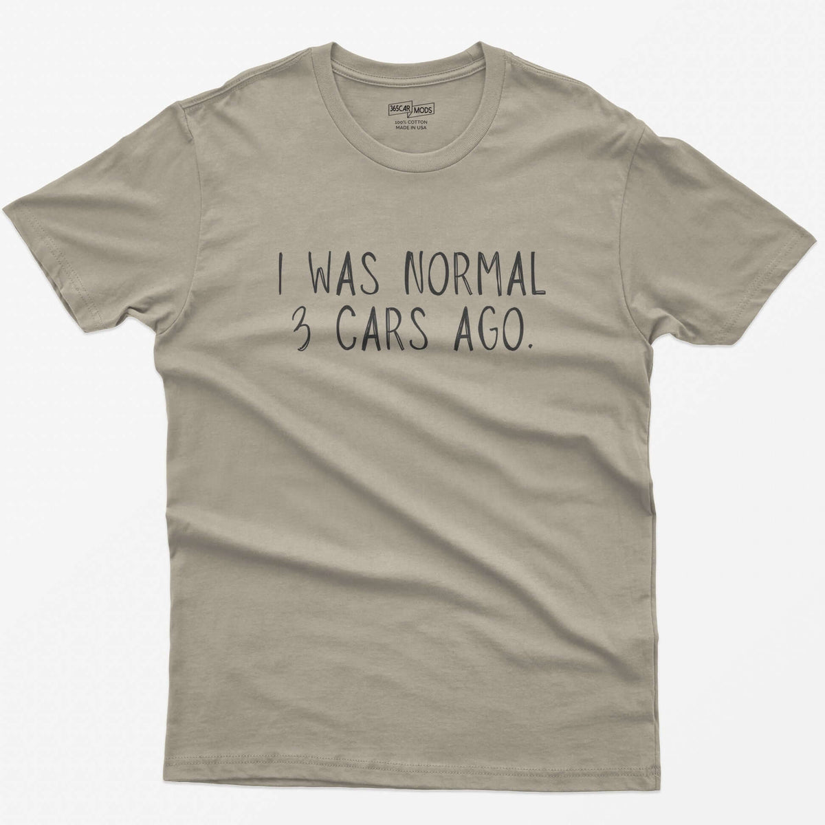 Sand t-shirt with thin hand-lettered white text reading I Was Normal 3 Cars Ago