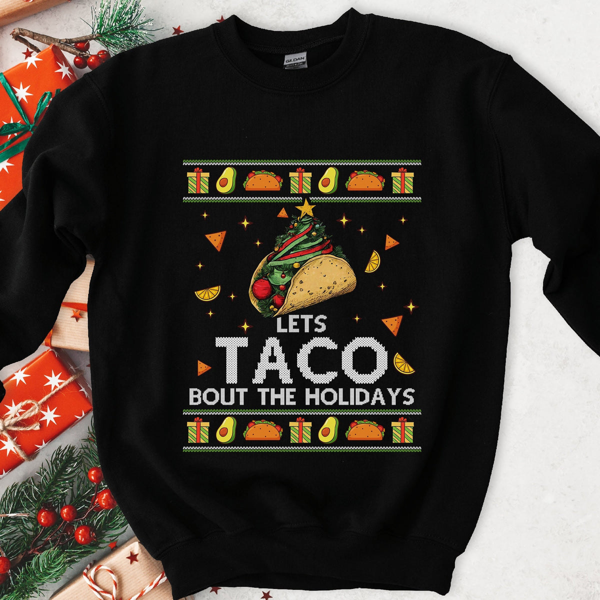 Black ugly Christmas sweatshirt with a taco Christmas tree and LETS TACO BOUT THE HOLIDAYS in a festive knit frame