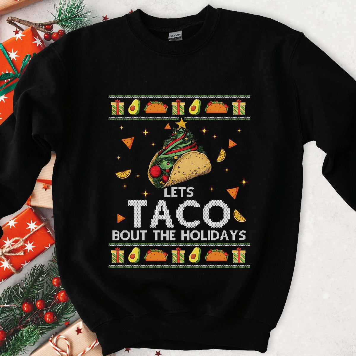 Black ugly Christmas sweatshirt with a taco Christmas tree and LETS TACO BOUT THE HOLIDAYS in a festive knit frame