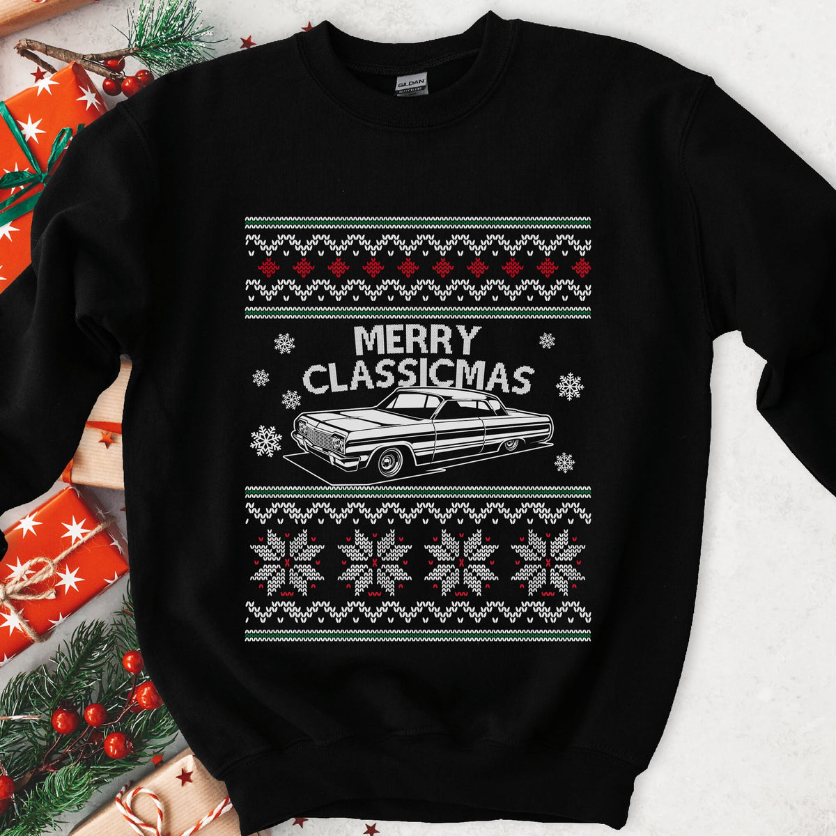 Dark Christmas sweatshirt with a 1960s lowrider under MERRY CLASSICMAS, framed by snowflake knit sweater bands