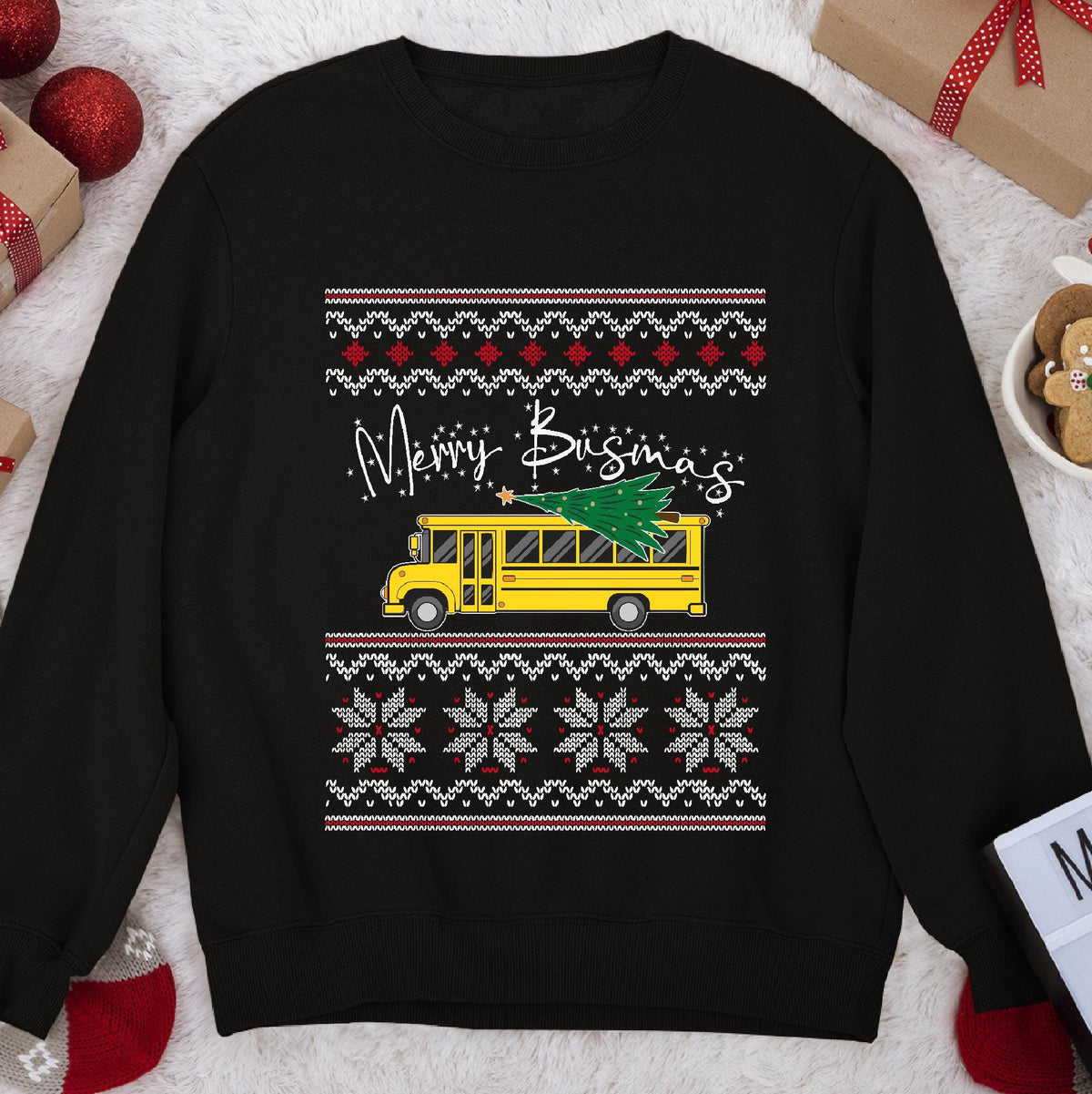Dark Christmas sweatshirt with a yellow school bus carrying a tree under script Merry Busmas, knit sweater bands