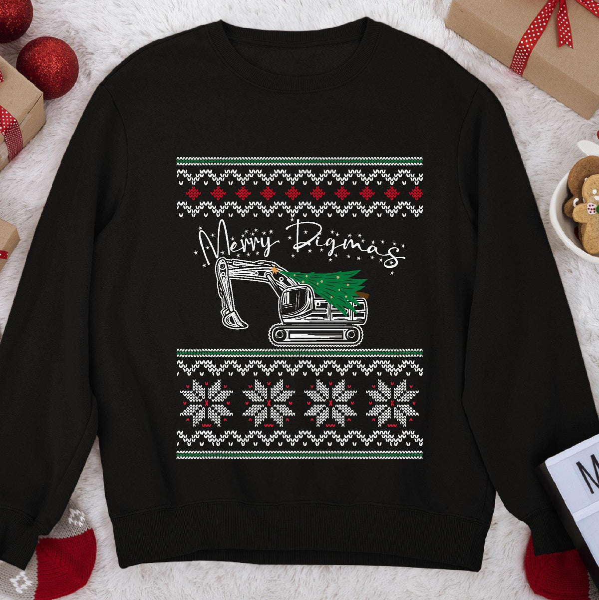 Dark Christmas sweatshirt with an excavator carrying a tree under script Merry Digmas, snowflake knit bands