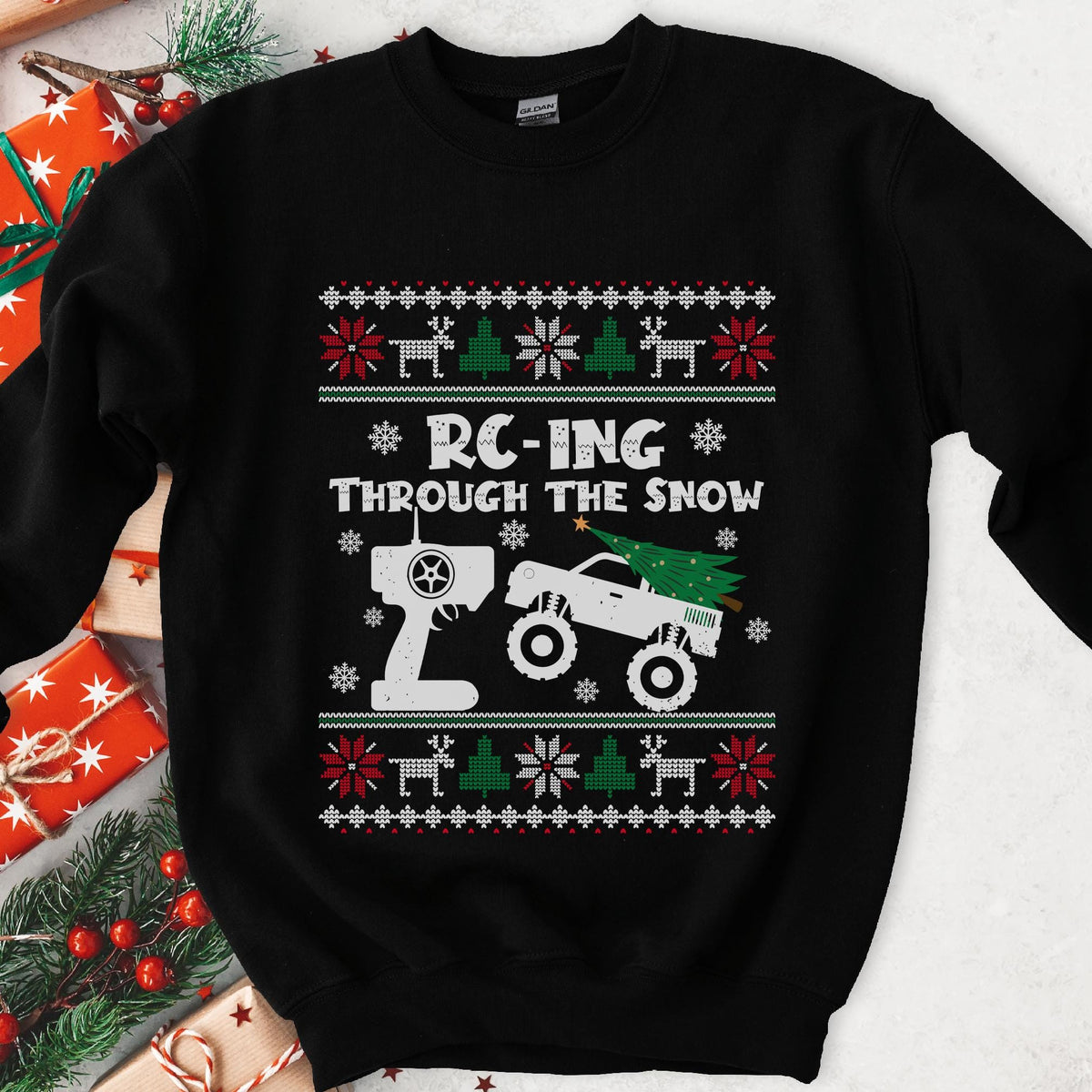 Dark Christmas sweatshirt with an RC monster truck and transmitter, RC-ING THROUGH THE SNOW, knit sweater borders