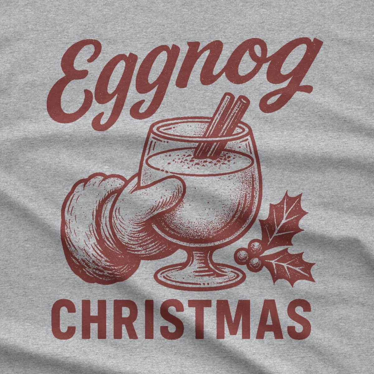 A red graphic of an eggnog drink in a glass with cinnamon sticks, held by a hand. The word "Eggnog" is above the glass, and the word "CHRISTMAS" is below. The image is on a gray background.