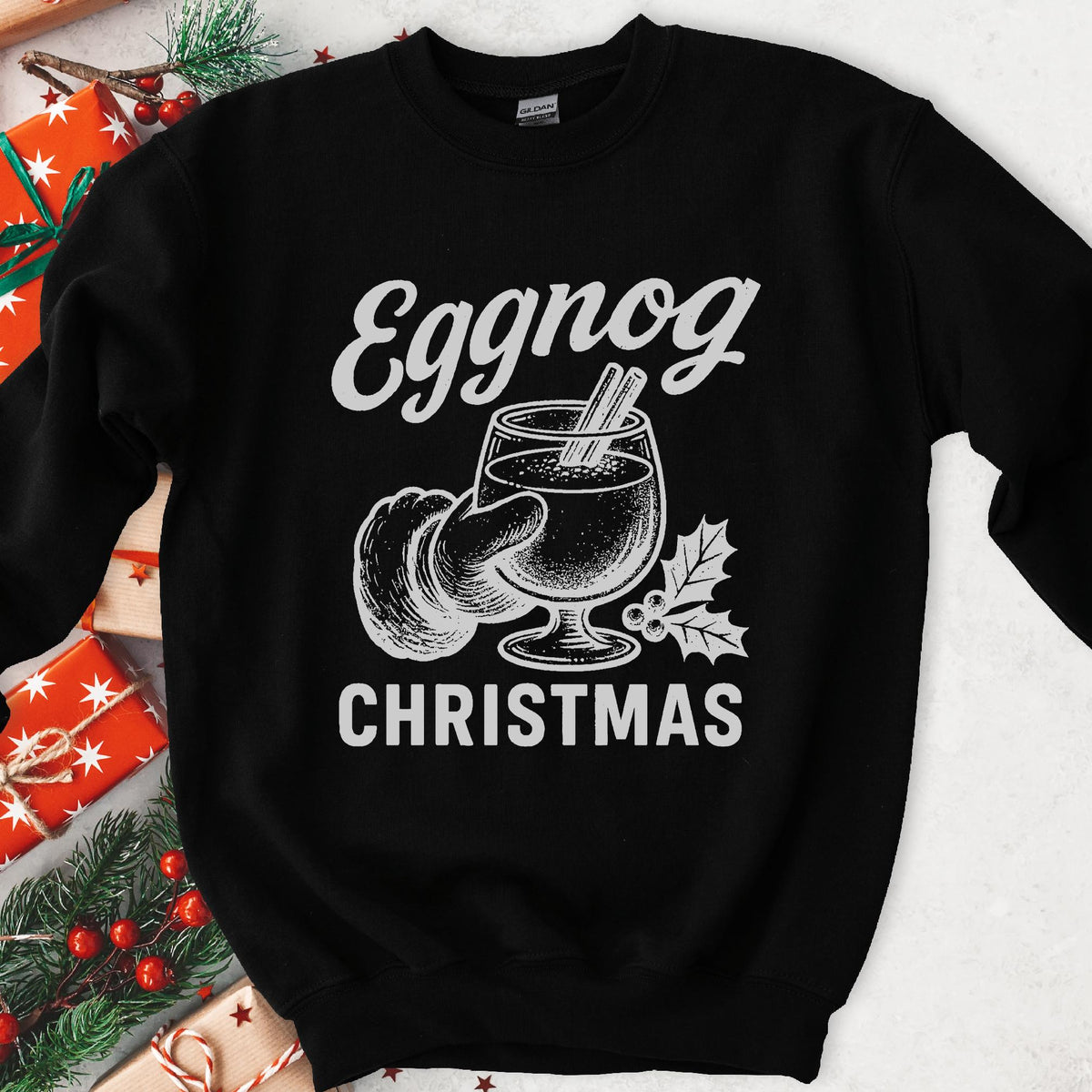 Dark sweatshirt with vintage gray art of Santa's hand holding eggnog with cinnamon sticks, text Eggnog Christmas